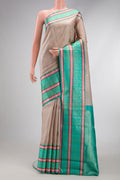 Beige Dual Tone Kanchipuram Silk Saree with Zari Butta on the body and Zari And Thread Border.  displayed on a mannequin