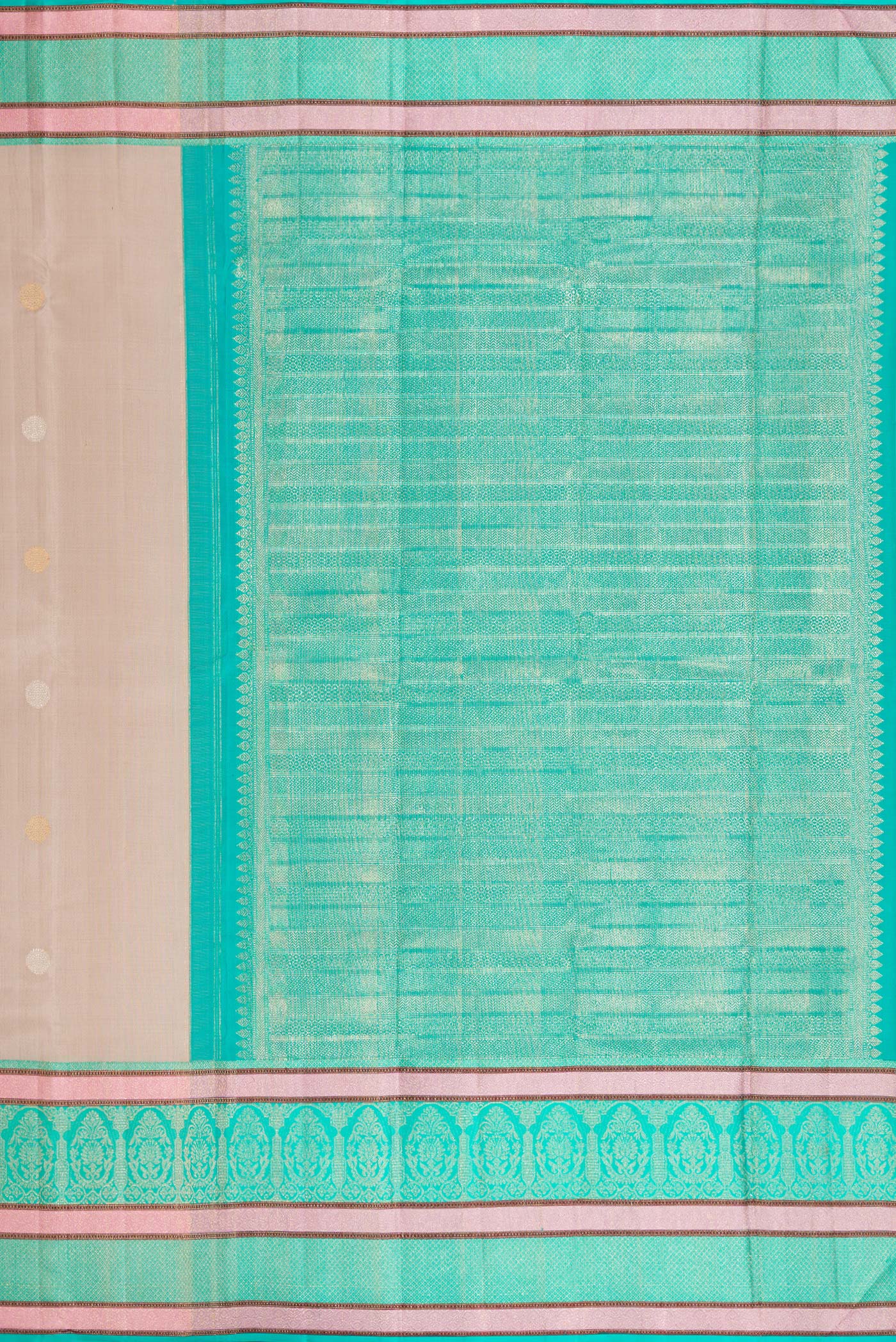Close up image of the pallu of Beige Dual Tone Kanchipuram Silk Saree with Zari Butta on the body and Zari And Thread Border. 