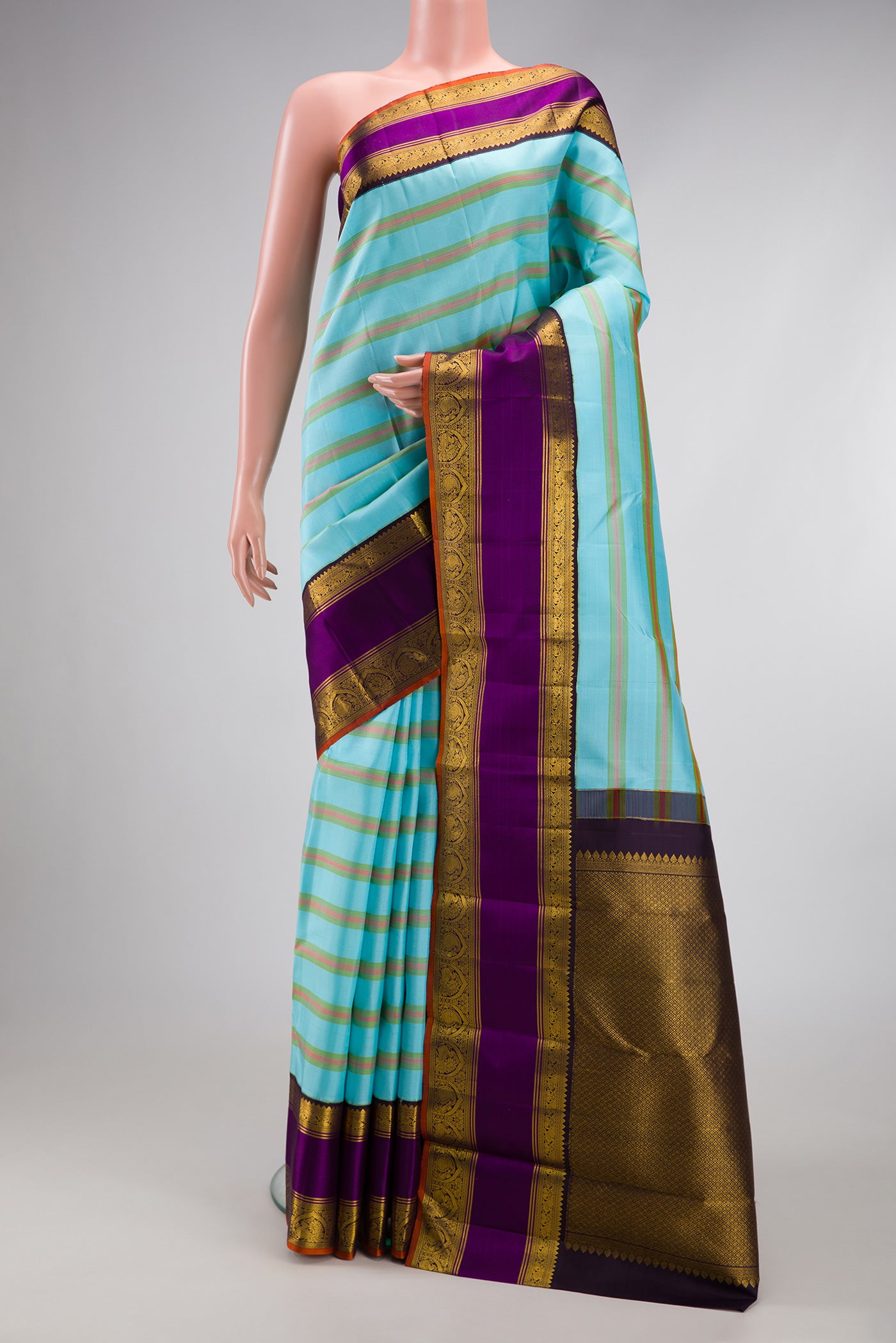 Sky Blue Kanchipuram Silk Saree with Stripes on the body and Zari Border.  displayed on a mannequin