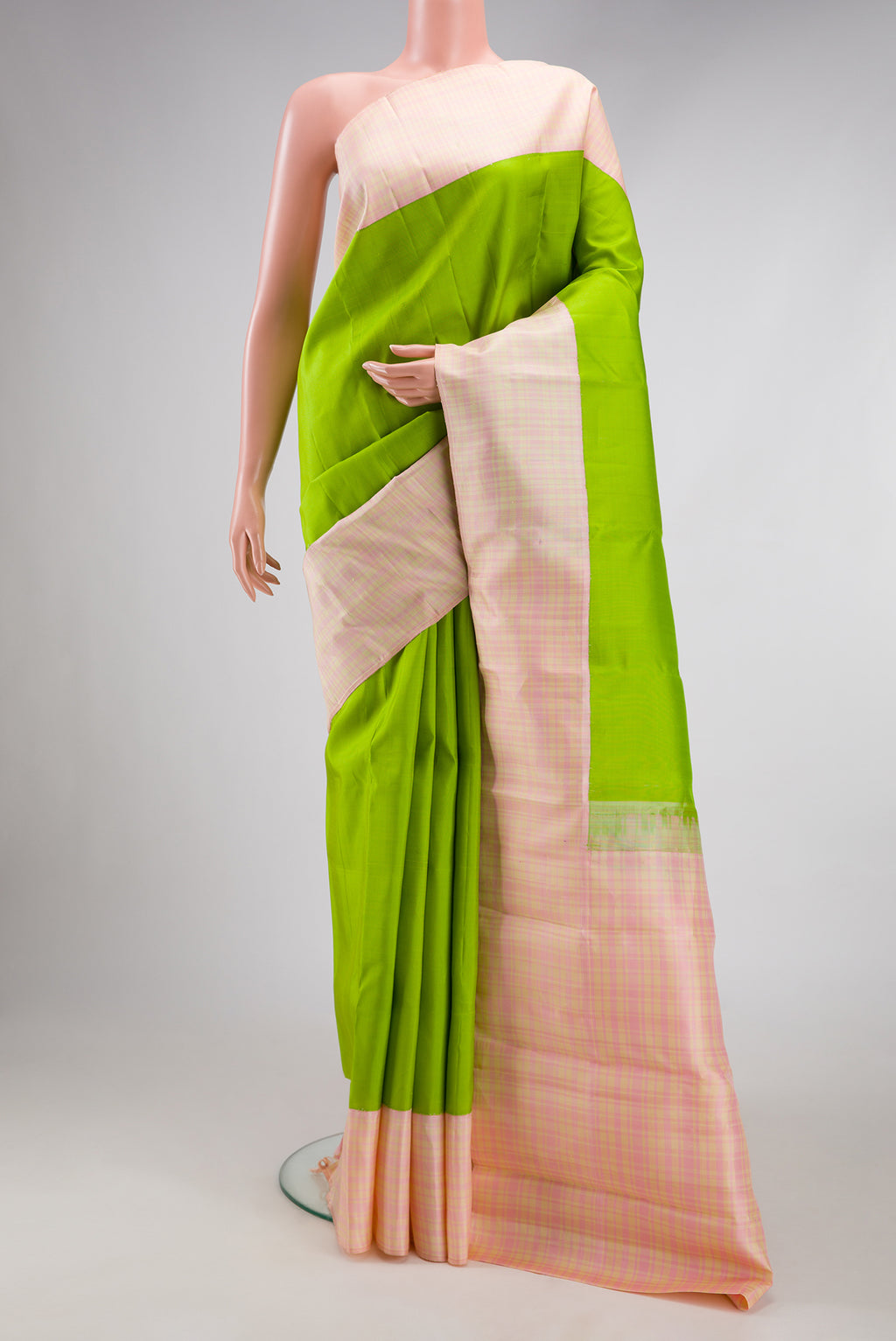 Parrot Green Kanjivaram Silk Saree with Plain Body and Thread Border.  displayed on a mannequin