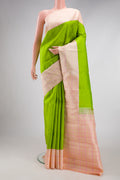 Parrot Green Kanjivaram Silk Saree with Plain Body and Thread Border.  displayed on a mannequin