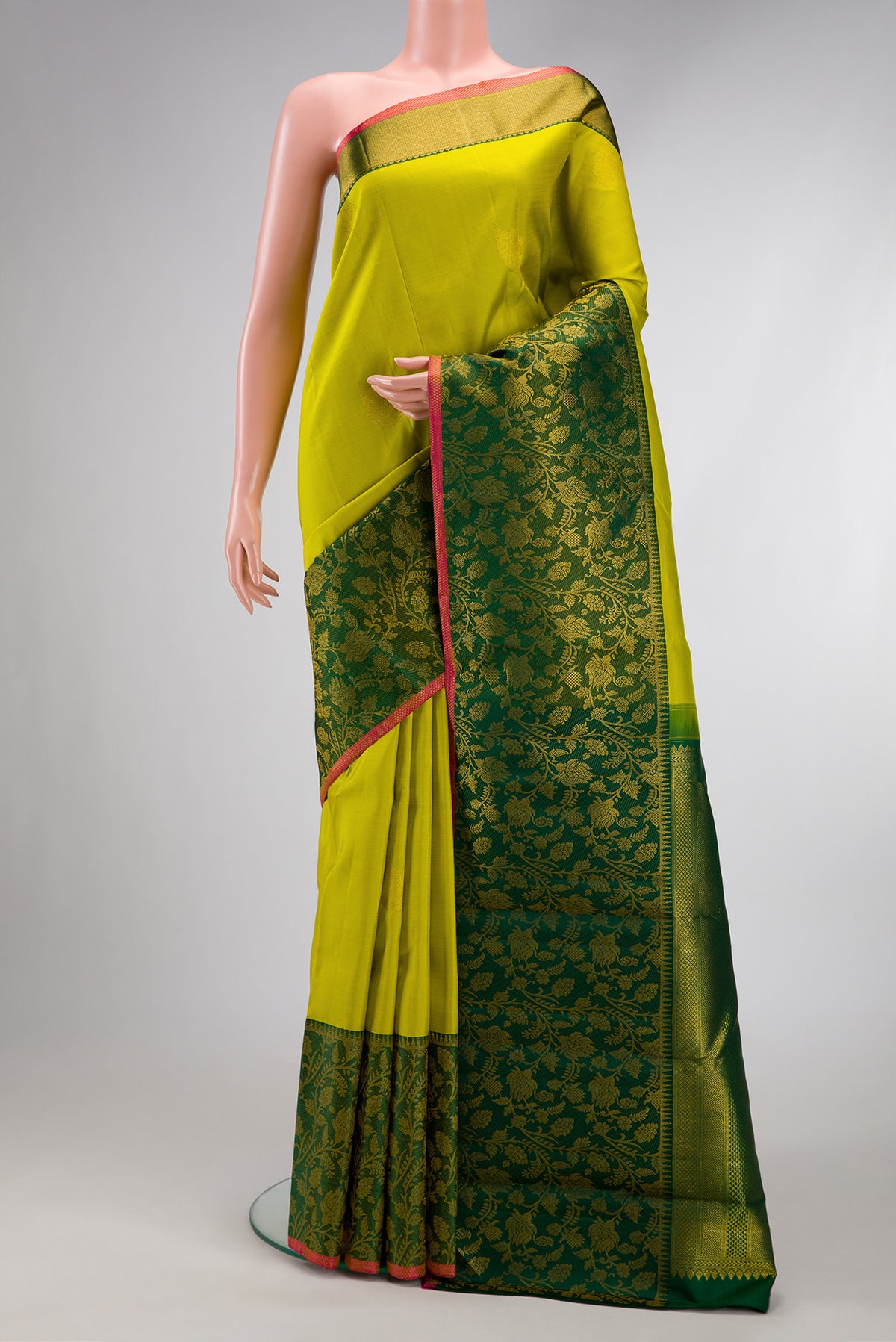 Parrot Green Dual Tone Kanchipuram Silk Saree with Zari Butta on the body and Fancy Border.  displayed on a mannequin