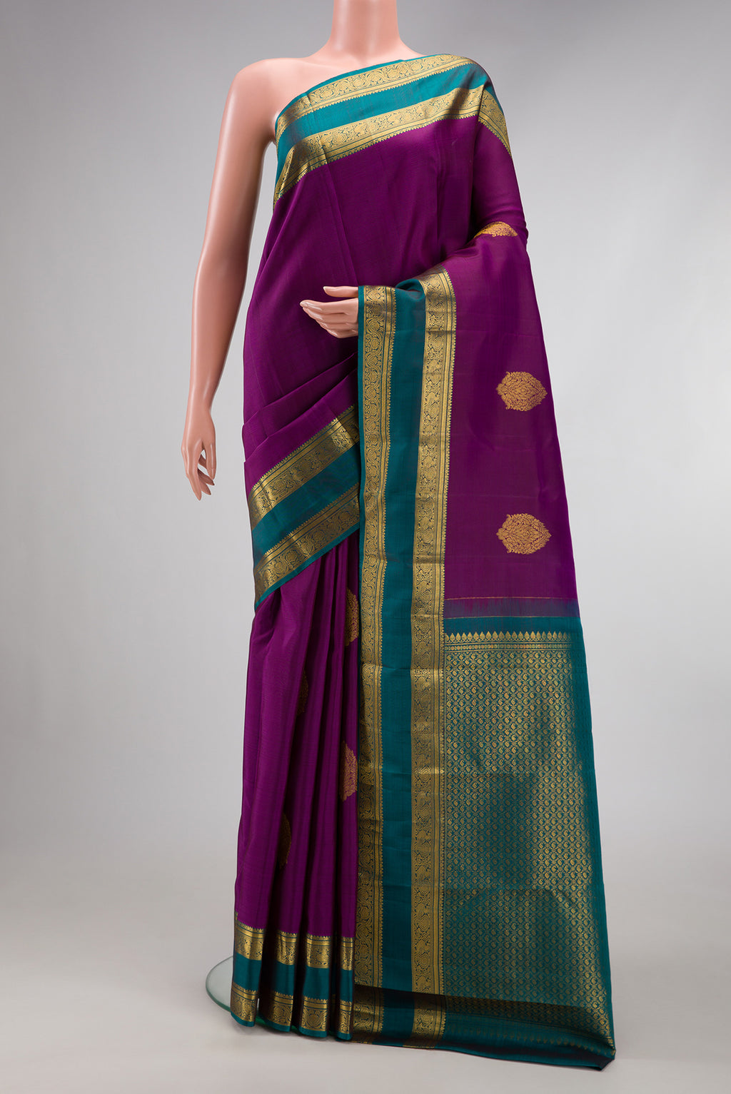 Purple Kanchipuram Silk Saree with Zari Butta on the body and Zari Border.  displayed on a mannequin