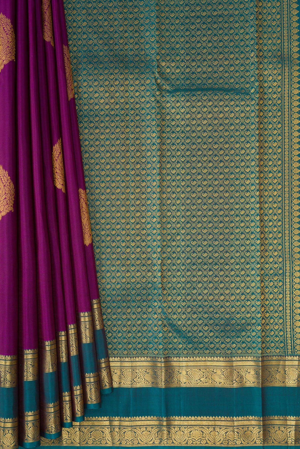 Pleats and pallu of Purple Kanchipuram Silk Saree with Zari Butta on the body and Zari Border. 