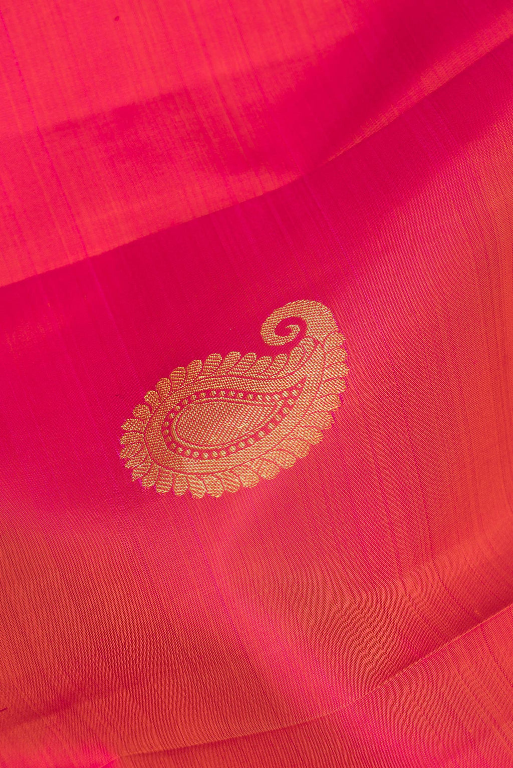 Close up of Pure Silk Orange Kanchipuram Saree with Zari Butta on the body and Zari Border.  displaying folds