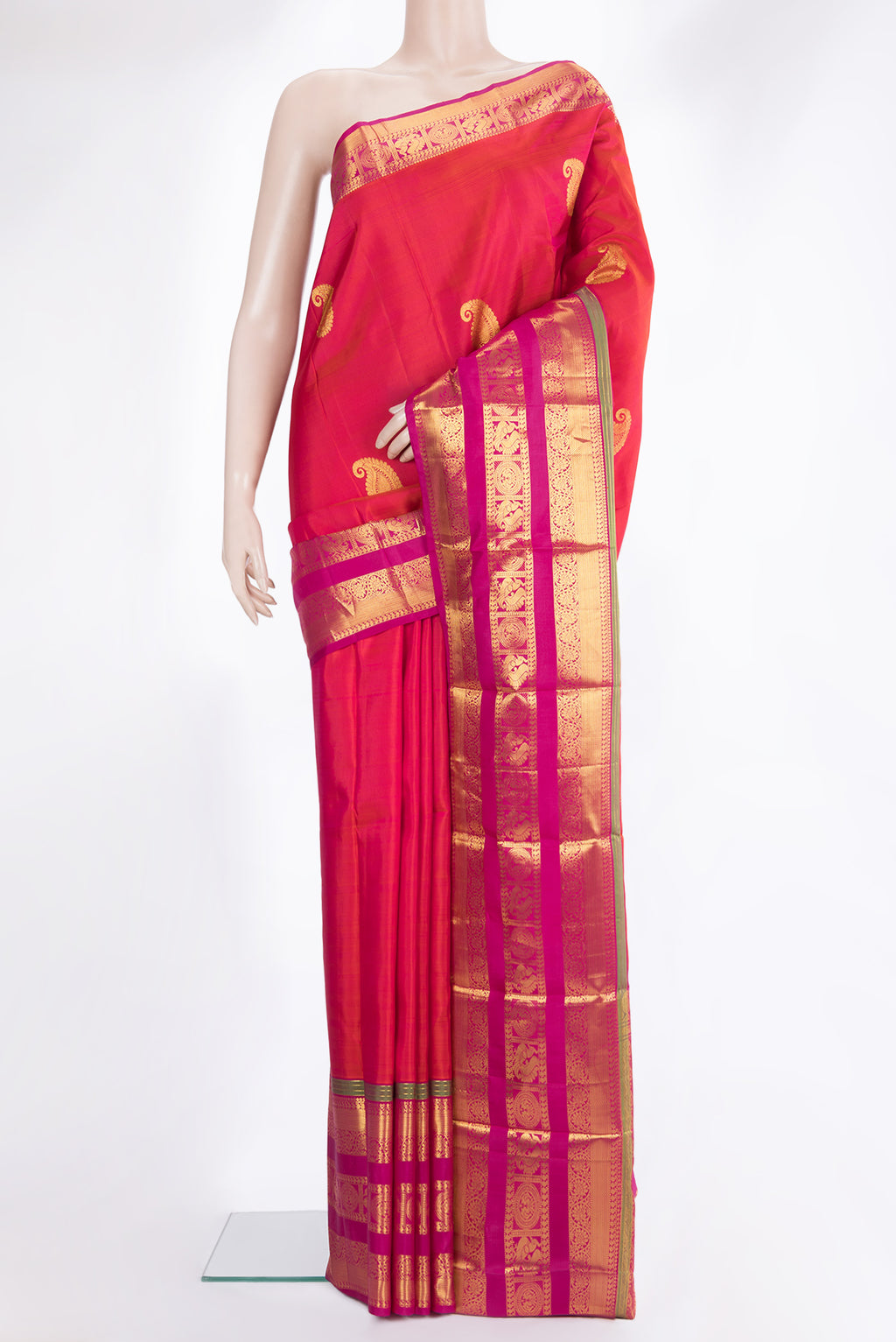 Pure Silk Orange Kanchipuram Saree with Zari Butta on the body and Zari Border.  displayed on a mannequin