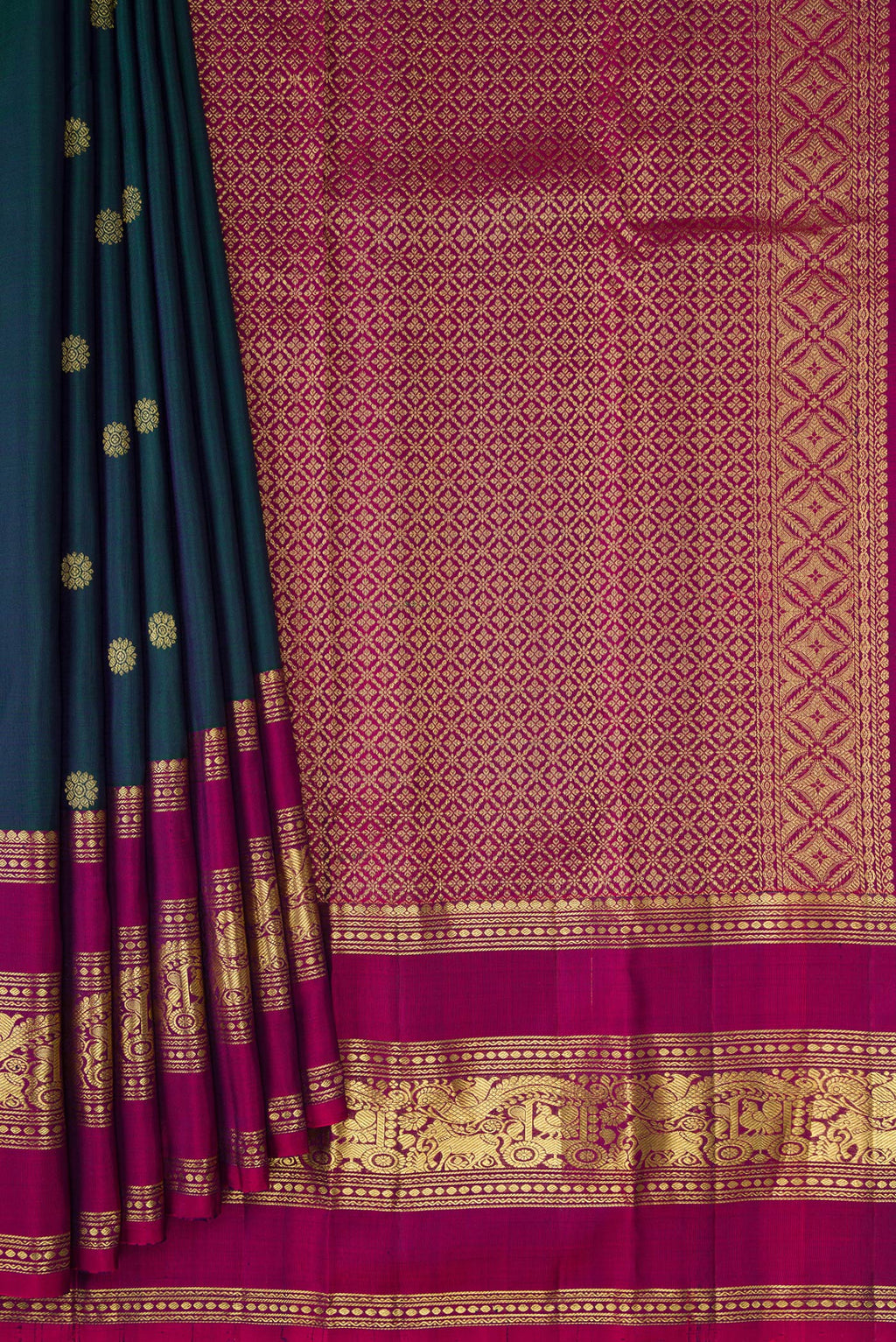 Pleats and pallu of Bottle Green Kanchipuram Silk Saree with Zari Butta on the body and Zari Border. 