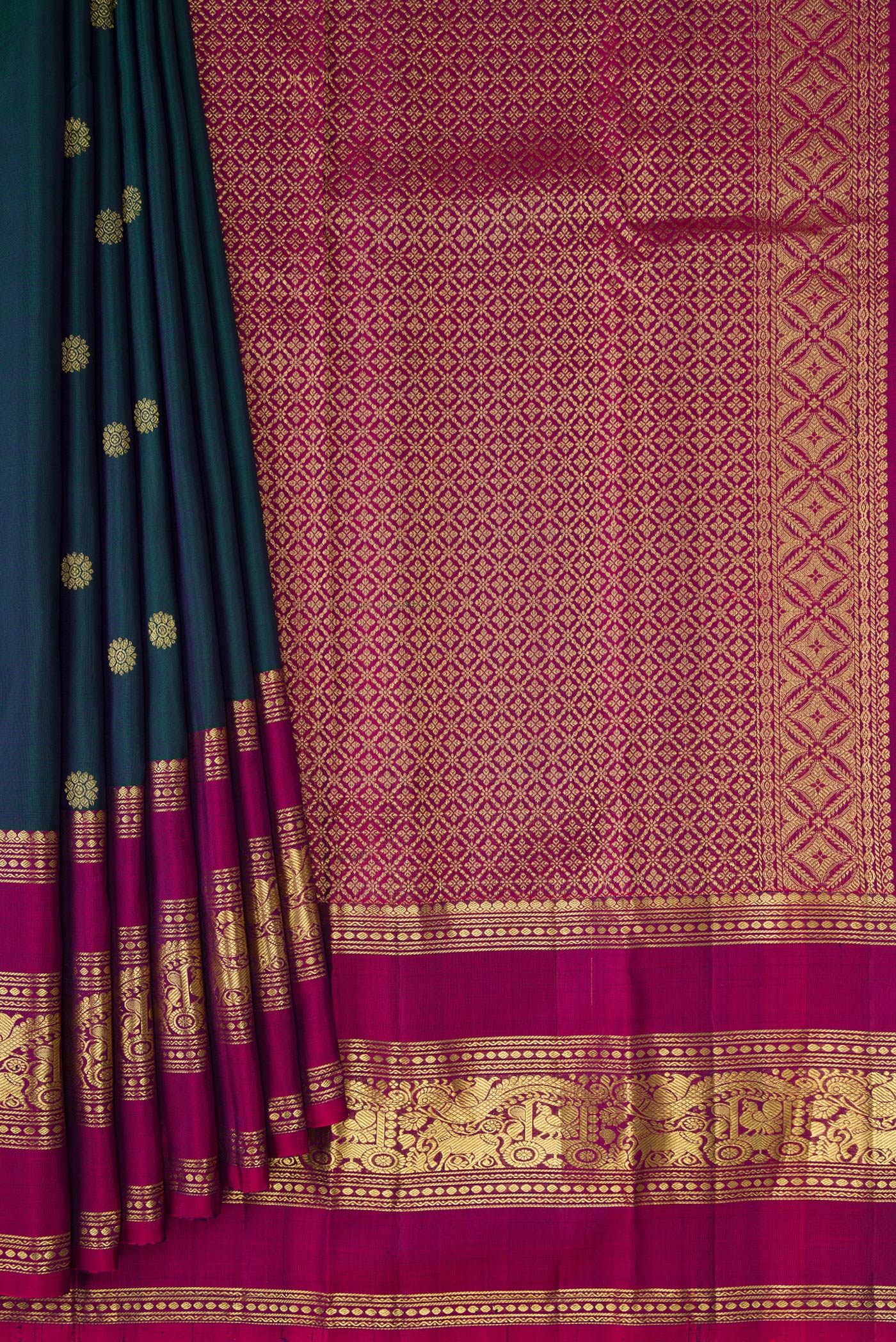 Pleats and pallu of Bottle Green Kanchipuram Silk Saree with Zari Butta on the body and Zari Border. 