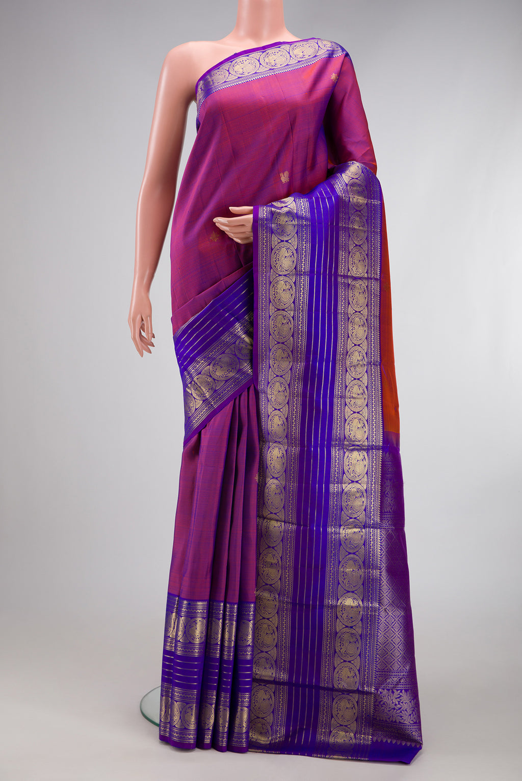 Purple Kanchipuram Silk Saree with Zari Butta on the body and Zari Border.  displayed on a mannequin