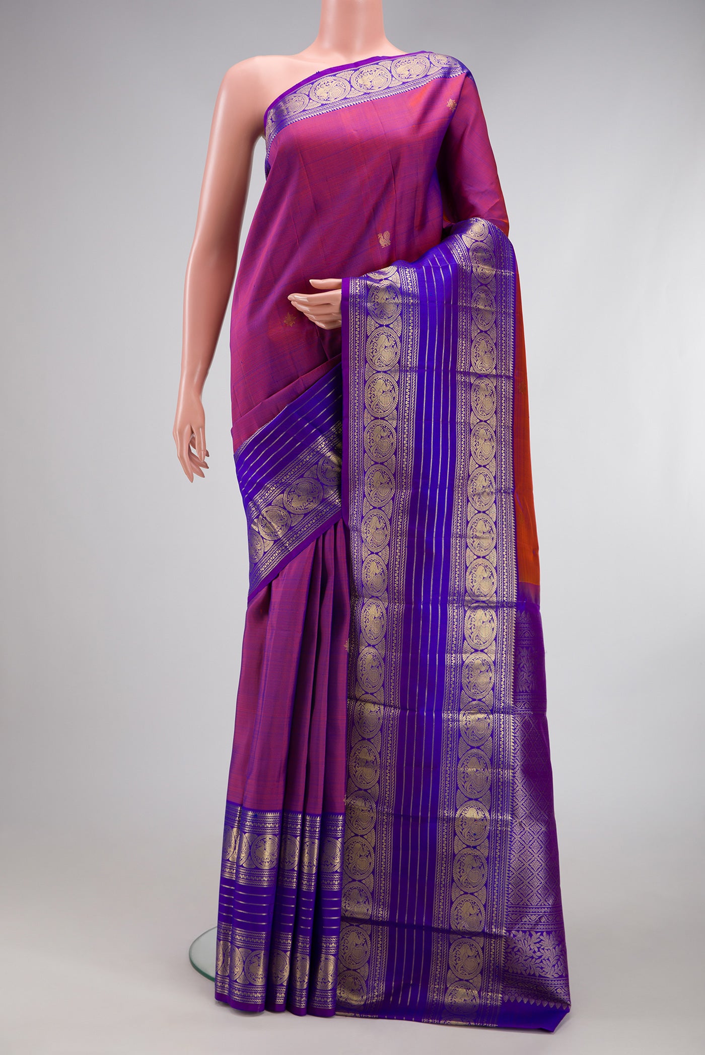 Purple Kanchipuram Silk Saree with Zari Butta on the body and Zari Border.  displayed on a mannequin