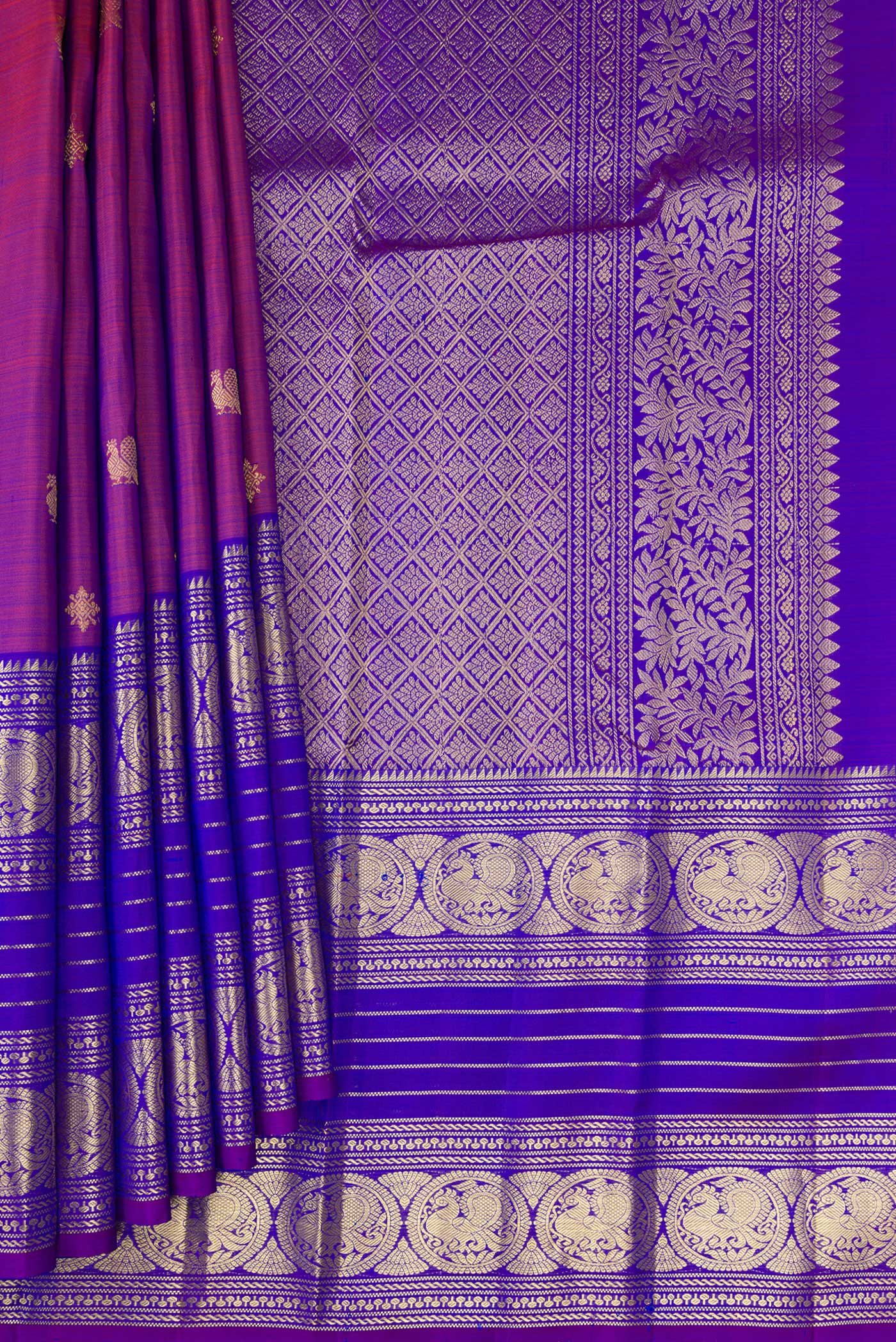 Pleats and pallu of Purple Kanchipuram Silk Saree with Zari Butta on the body and Zari Border. 
