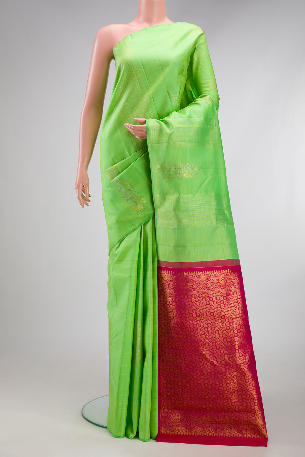 Pista Green Kanchipuram Silk Saree with Zari Butta on the body and Without Border.  displayed on a mannequin