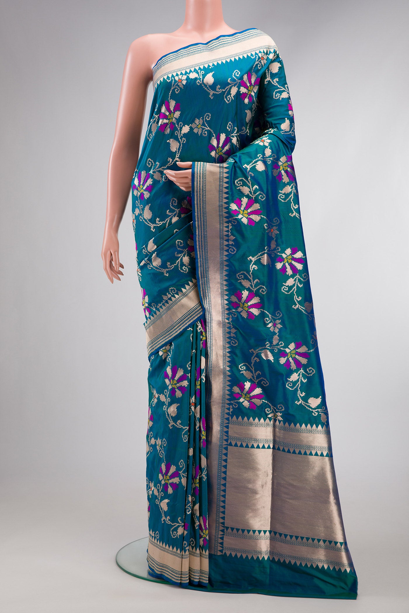 Peacock Blue Dual Tone Banarasi Silk Saree with Zari Butta on the body and Zari Border.  displayed on a mannequin