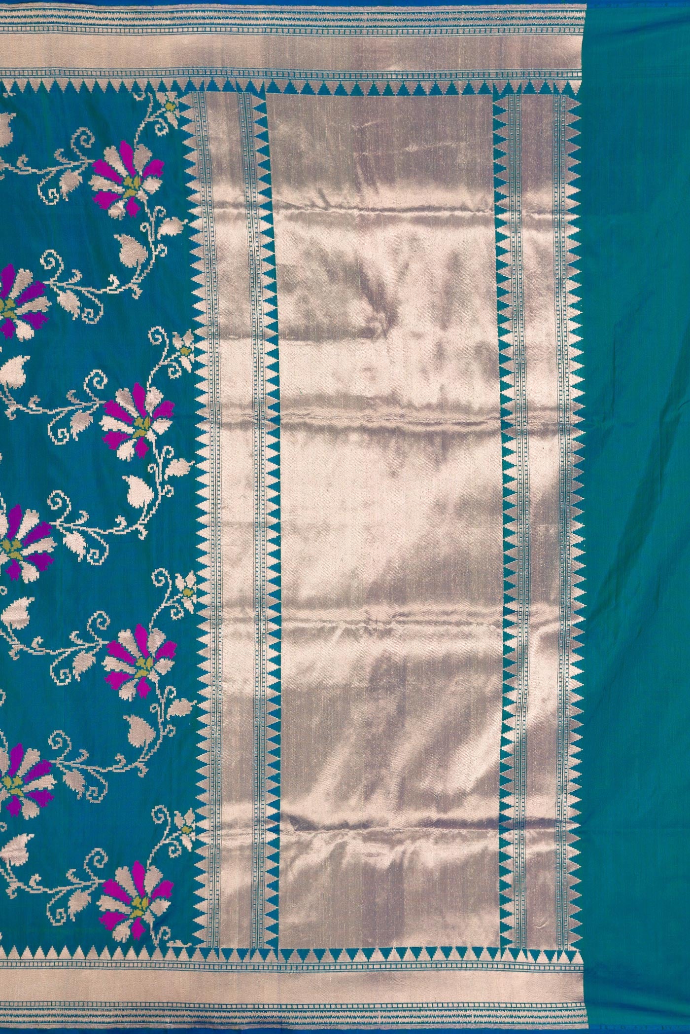 Close up image of the pallu of Peacock Blue Dual Tone Banarasi Silk Saree with Zari Butta on the body and Zari Border. 