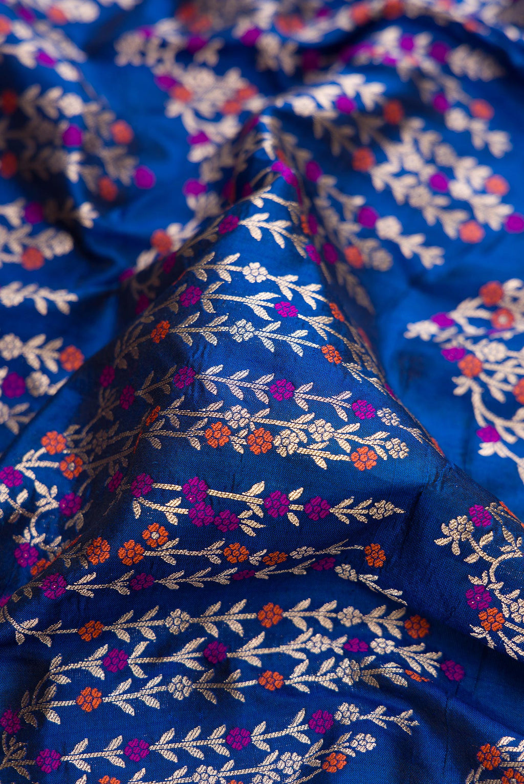 Close up of Royal Blue Dual Tone Banarasi Silk Saree with Zari Brocade on the body and Zari Border.  displaying folds