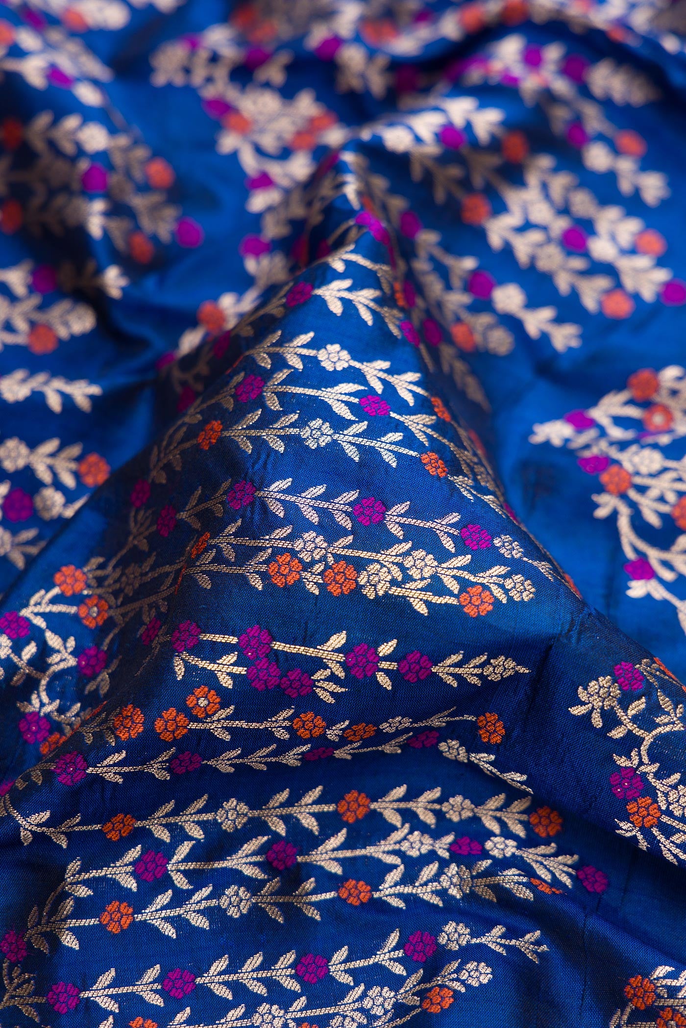 Close up of Royal Blue Dual Tone Banarasi Silk Saree with Zari Brocade on the body and Zari Border.  displaying folds