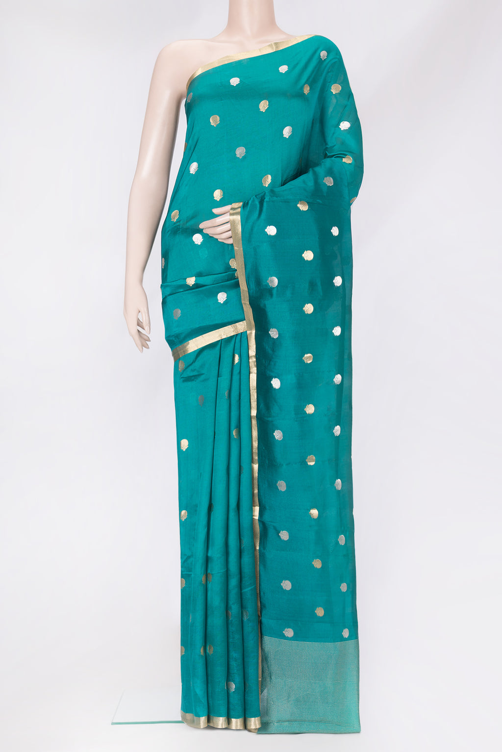 Peacock Blue Tussar Silk Saree with Zari Butta on the body and Zari Border.  displayed on a mannequin