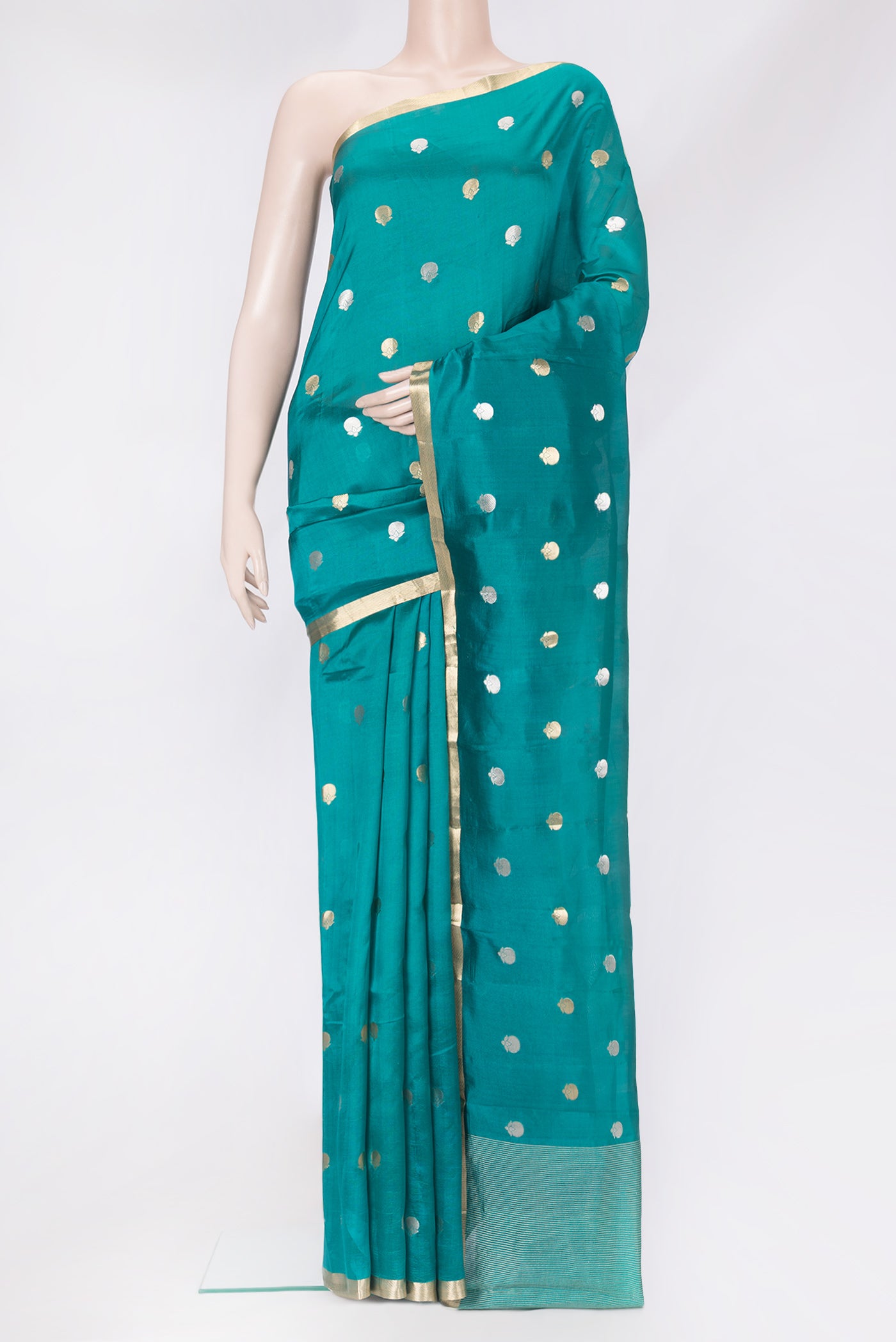 Peacock Blue Tussar Silk Saree with Zari Butta on the body and Zari Border.  displayed on a mannequin