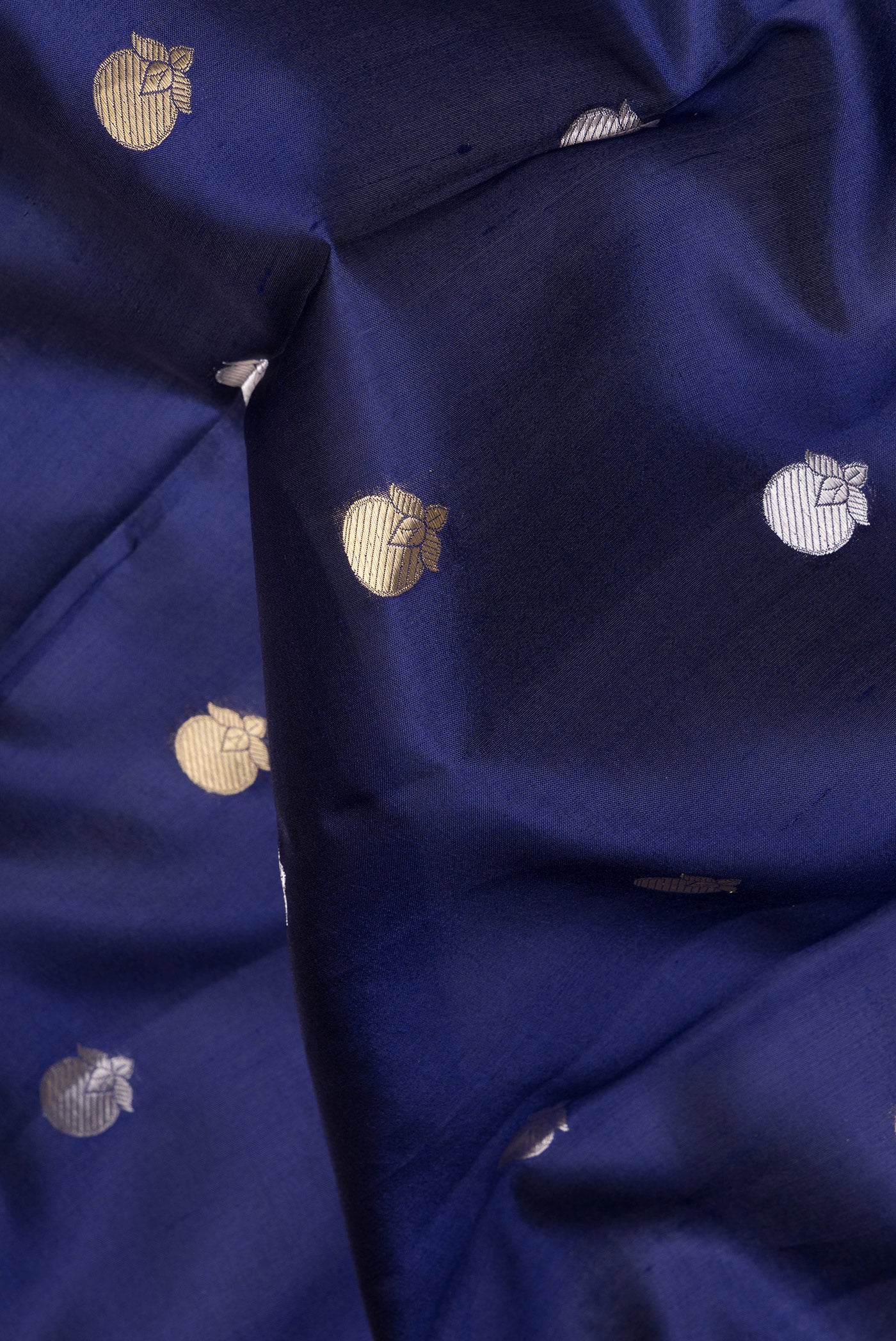 Close up of Navy Blue Tussar Silk Saree with Zari Butta on the body and Zari Border.  displaying folds