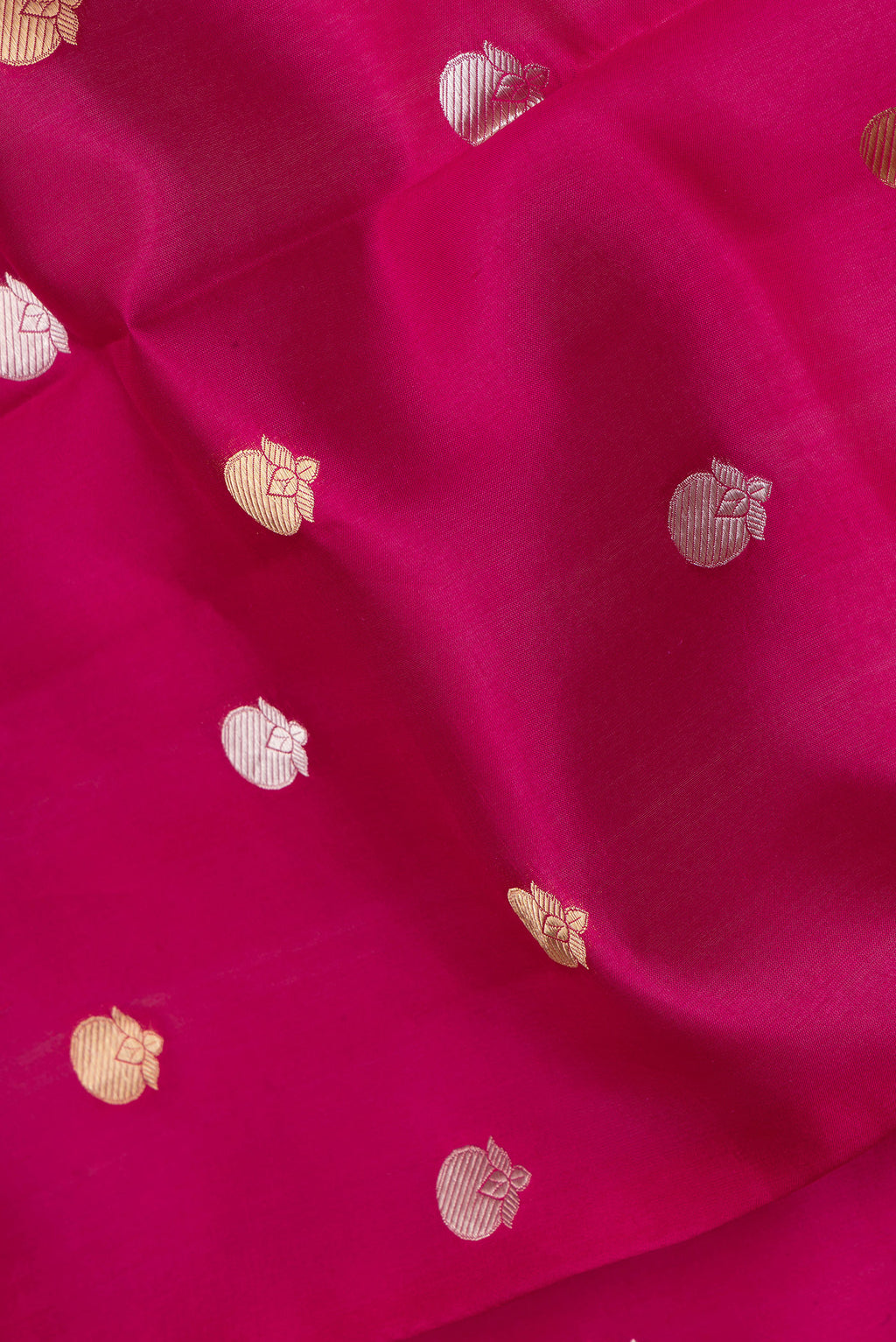 Close up of Dark Pink Tussar Silk Saree with Zari Butta on the body and Zari Border.  displaying folds