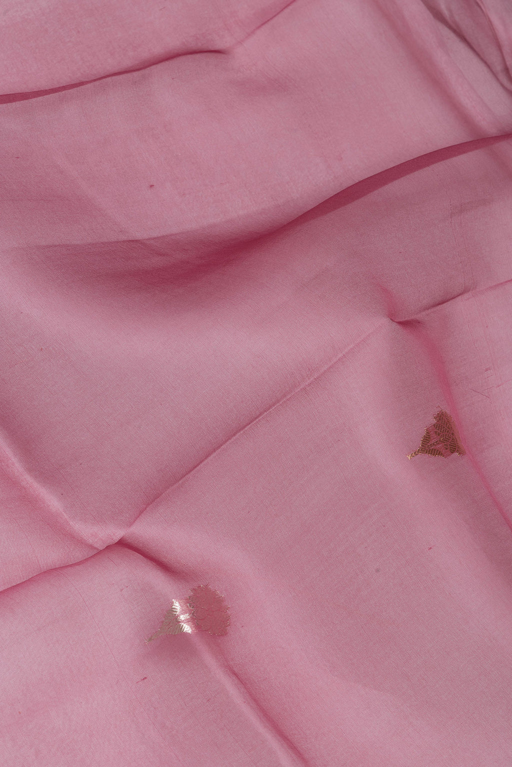 Close up of Pink Organza Silk Saree with Zari Butta on the body and Fancy Border.  displaying folds