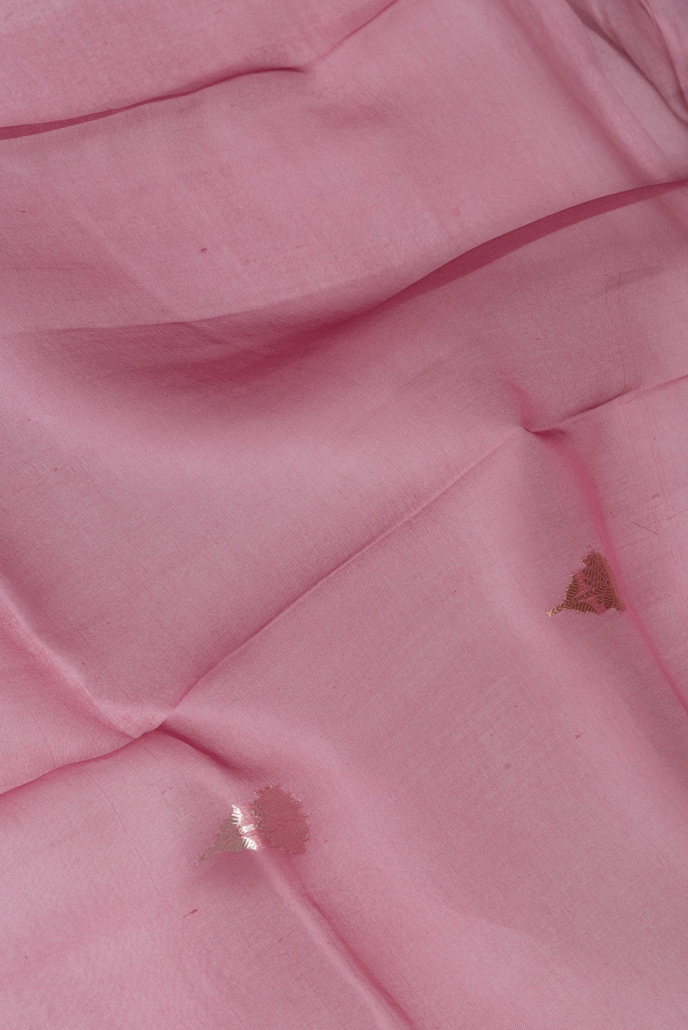 Close up of Pink Organza Silk Saree with Zari Butta on the body and Fancy Border.  displaying folds