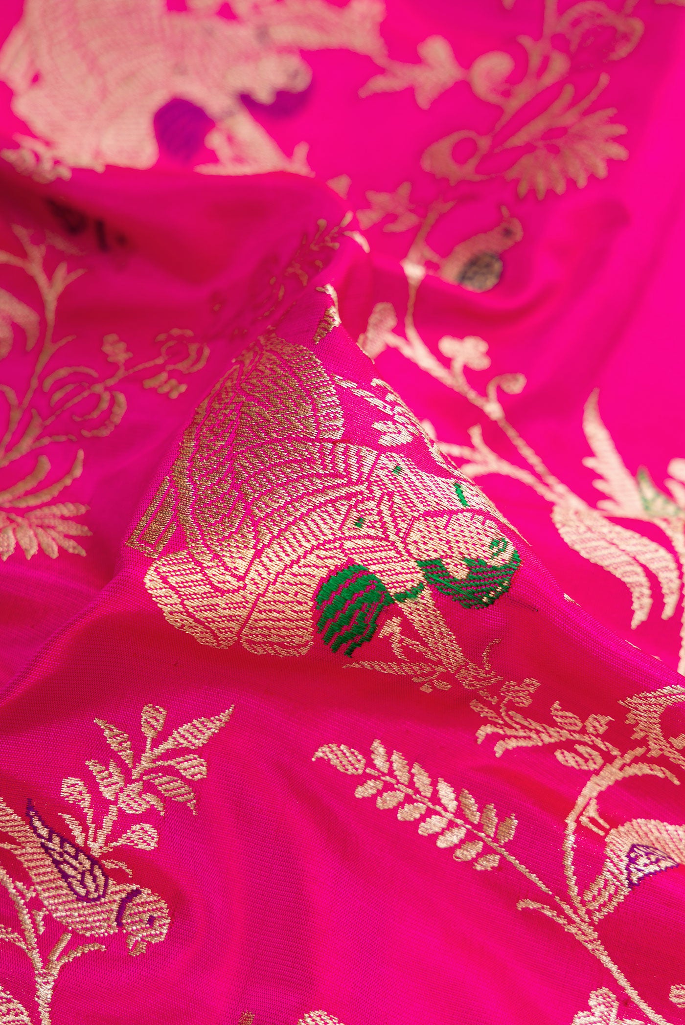 Close up of Pink Banarasi Silk Saree with Zari Butta on the body and Zari Border.  displaying folds