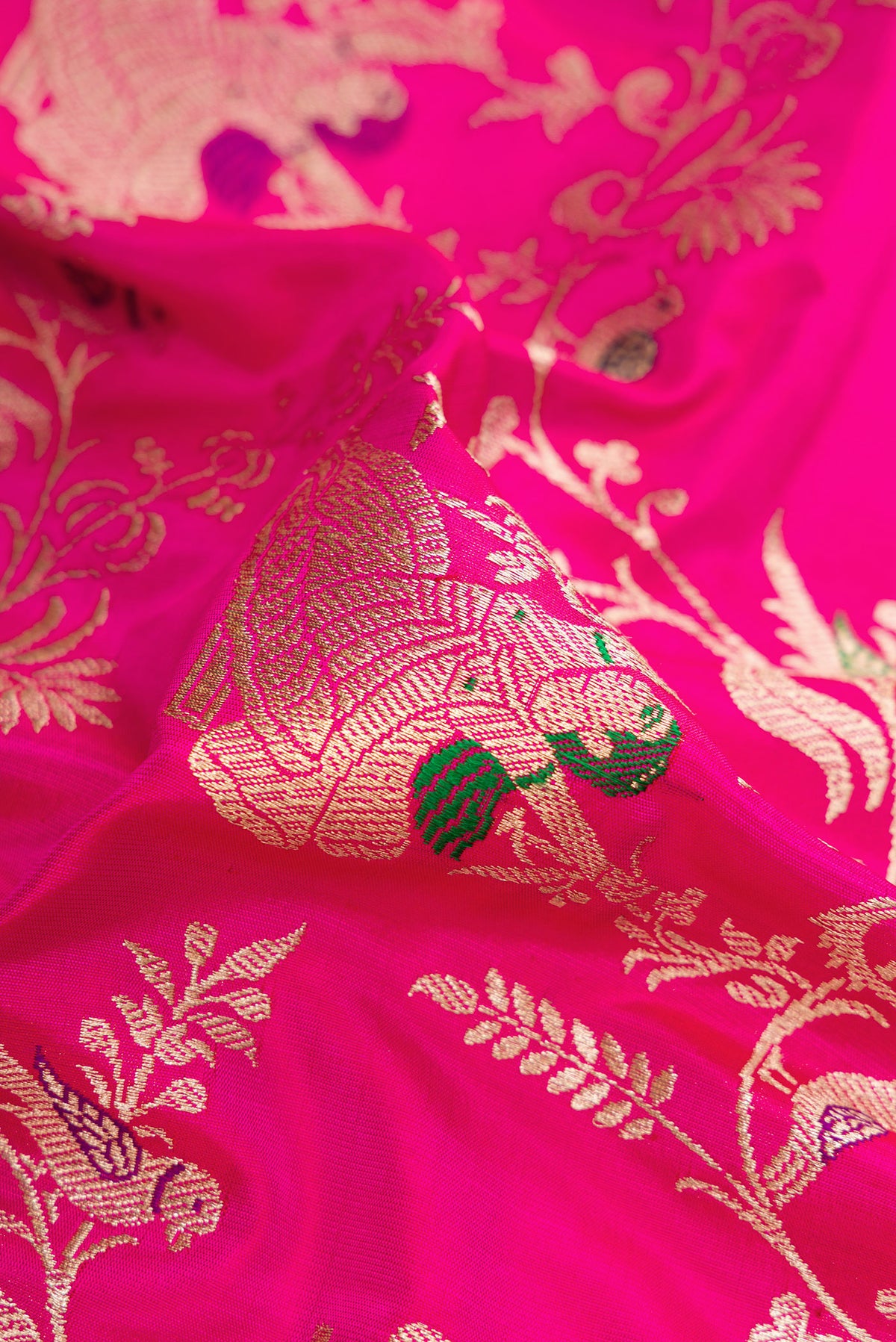 Close up of Pink Banarasi Silk Saree with Zari Butta on the body and Zari Border.  displaying folds