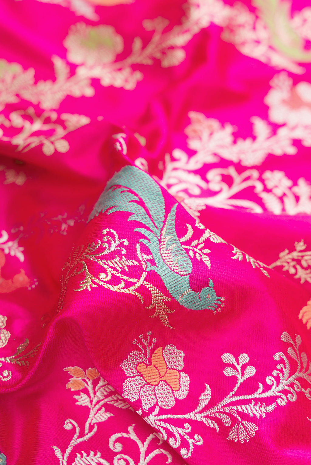Close up of Dark Pink Dual Tone Banarasi Silk Saree with Zari Brocade on the body and Zari Border.  displaying folds