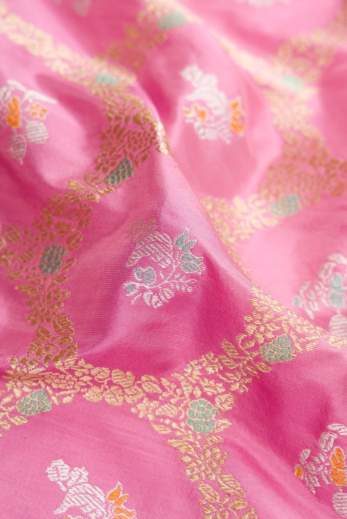 Close up of Pink Dual Tone Banarasi Silk Saree with Zari Butta on the body and Zari Border.  displaying folds
