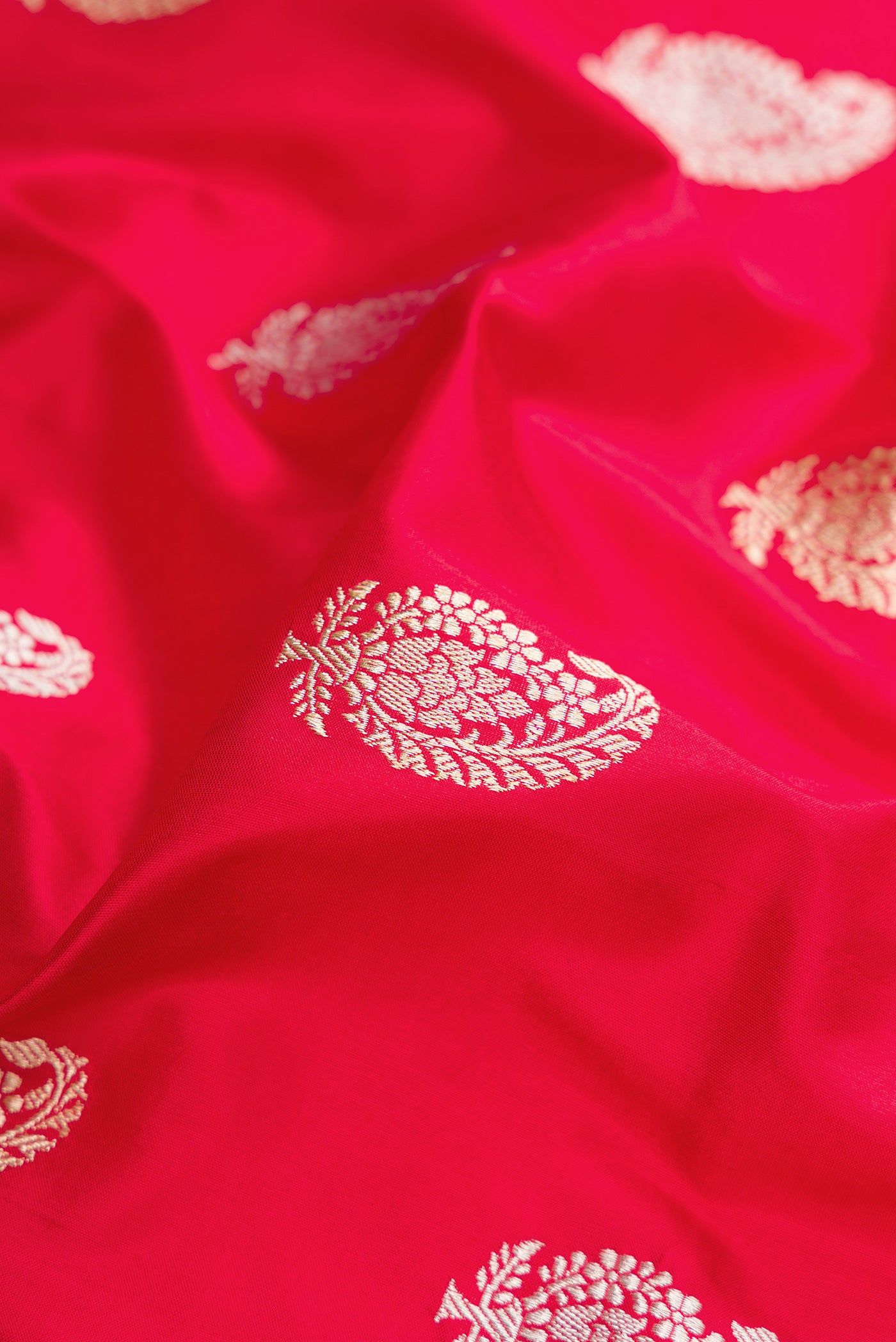 Close up of Dark Pink Dual Tone Banarasi Silk Saree with Zari Butta on the body and Zari Border.  displaying folds