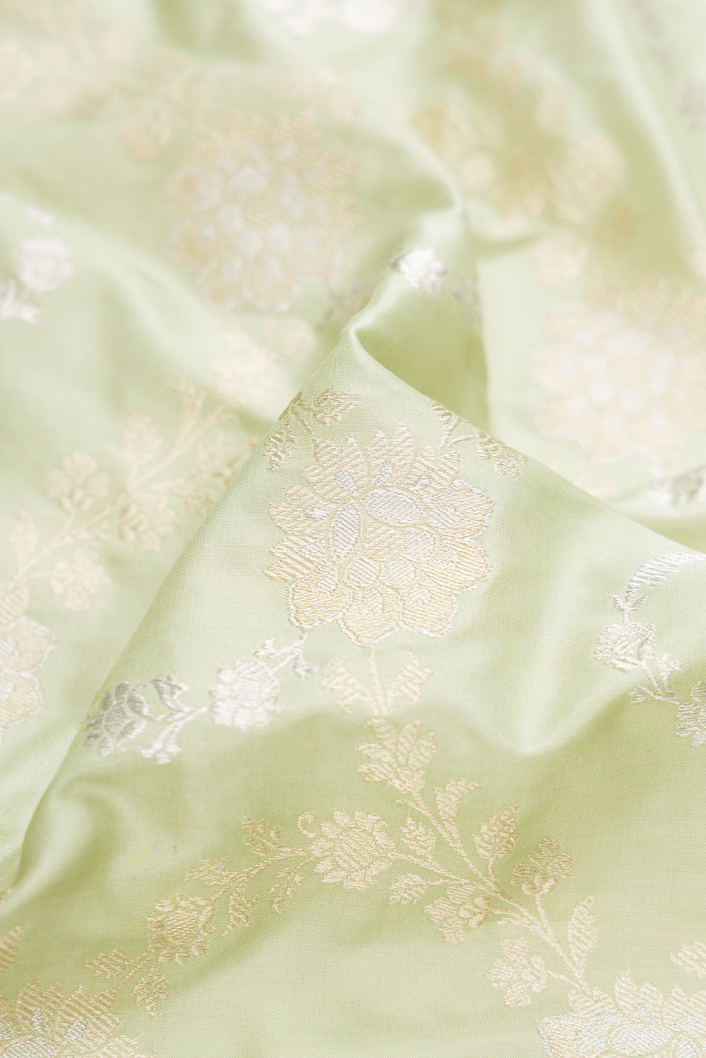 Close up of Pista Green Dual Tone Banarasi Silk Saree with Zari Brocade on the body and Zari Border.  displaying folds