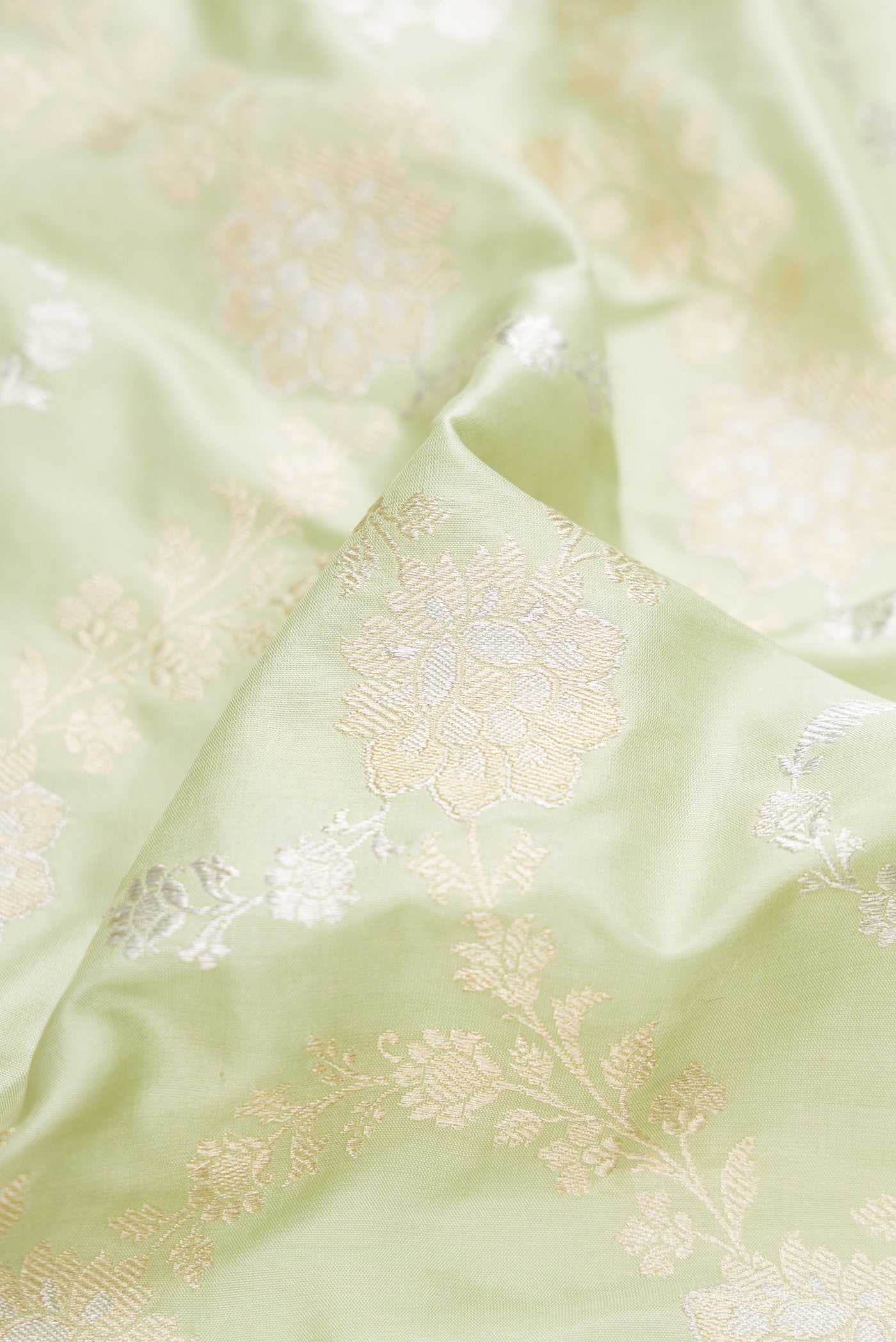 Close up of Pista Green Dual Tone Banarasi Silk Saree with Zari Brocade on the body and Zari Border.  displaying folds