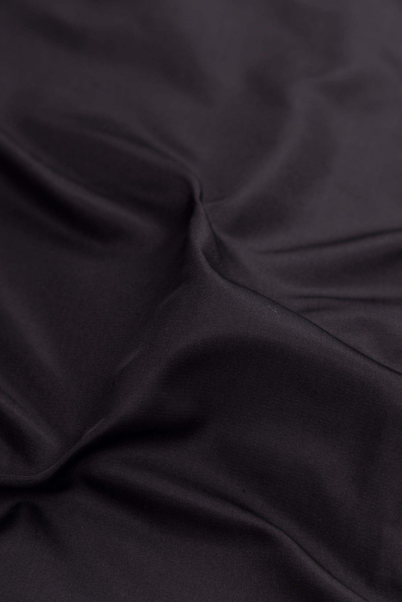 Close up of Black Banarasi Silk Saree with Plain Body and Zari Border.  displaying folds