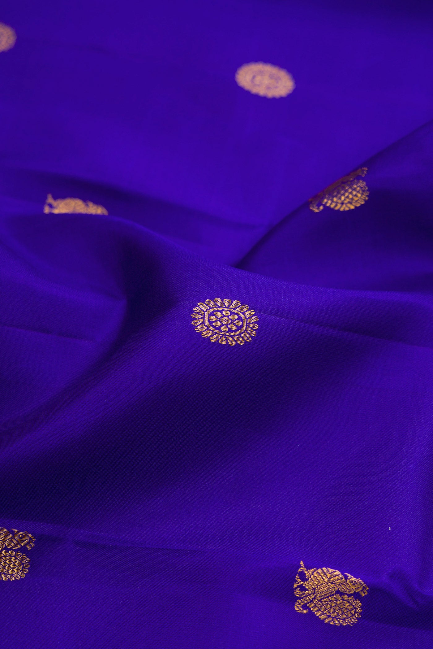 Close up of Royal Blue Kanjivaram Silk Saree with Zari Butta on the body and Zari Border.  displaying folds