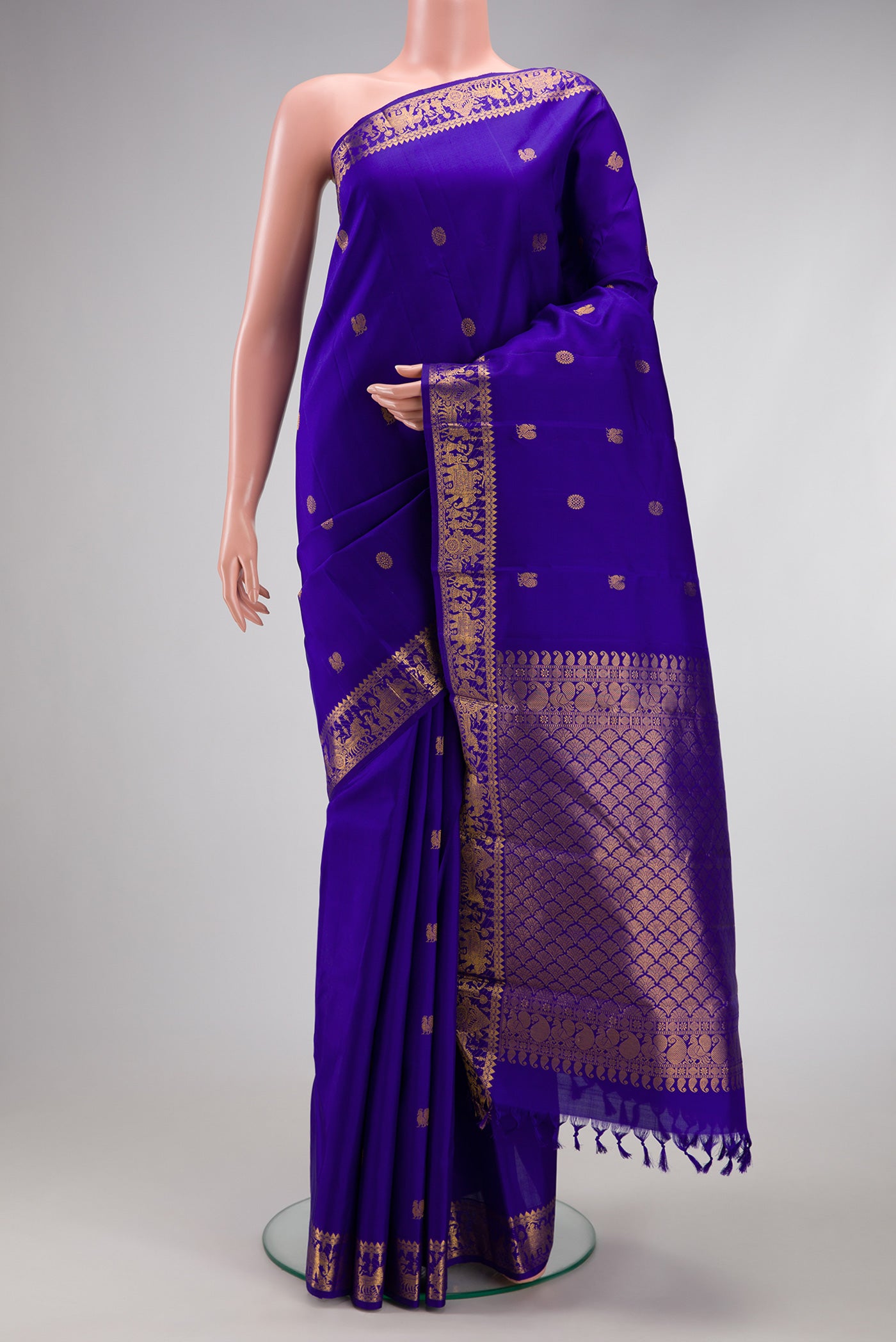 Royal Blue Kanjivaram Silk Saree with Zari Butta on the body and Zari Border.  displayed on a mannequin