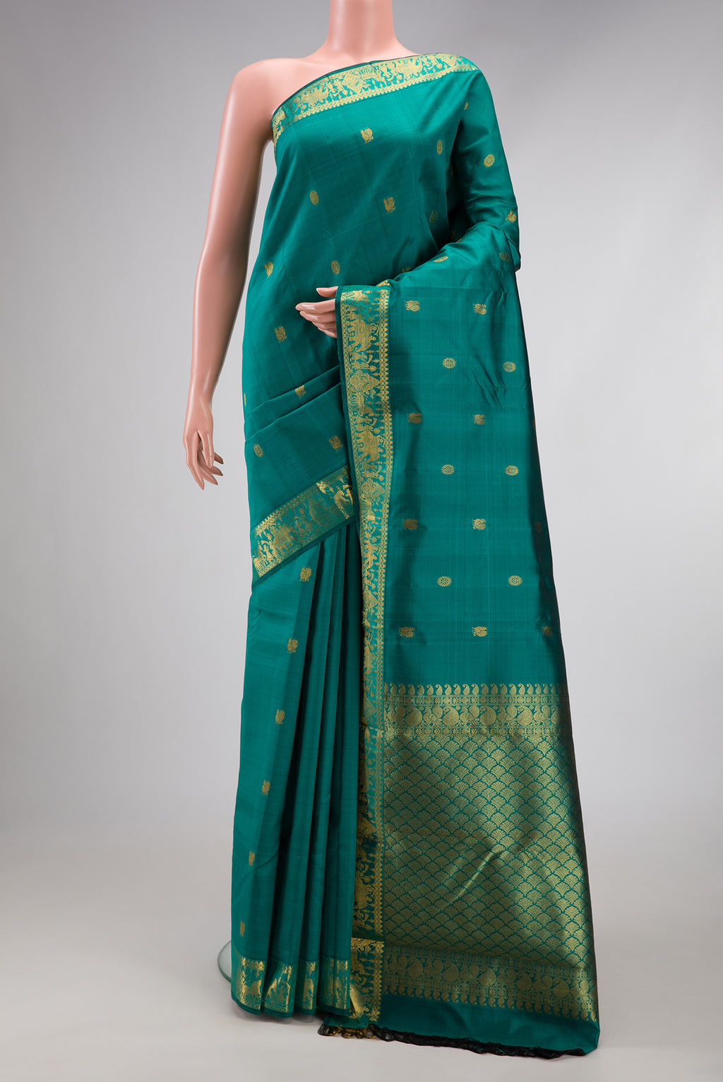 Teal Kanjivaram Silk Saree with Zari Butta on the body and Zari Border.  displayed on a mannequin