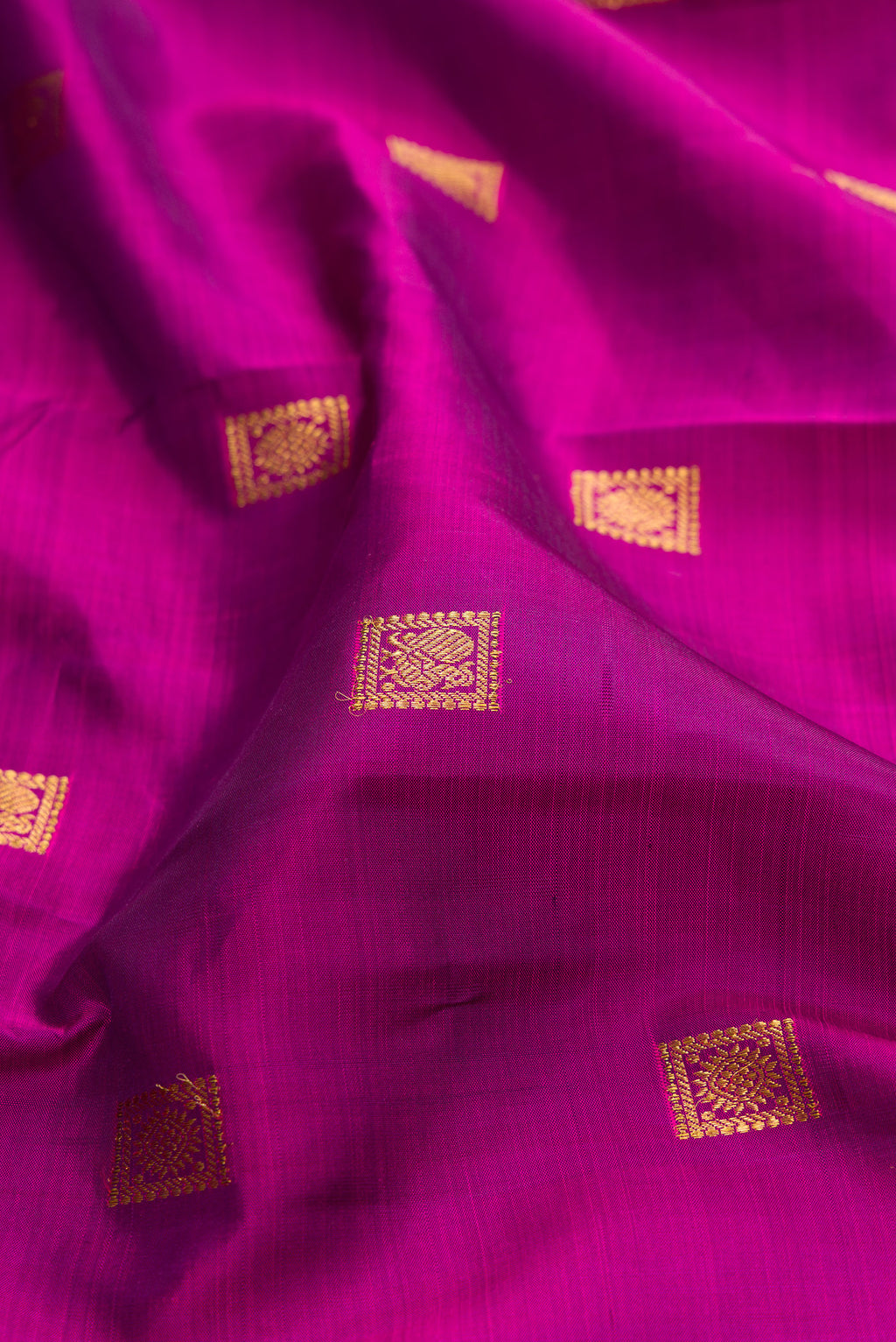 Close up of Purple Kanjivaram Silk Saree with Zari Butta on the body and Zari Border.  displaying folds
