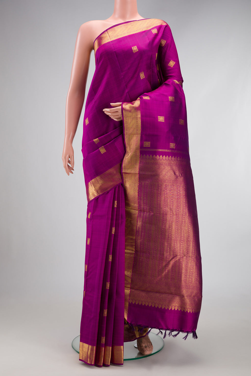 Purple Kanjivaram Silk Saree with Zari Butta on the body and Zari Border.  displayed on a mannequin
