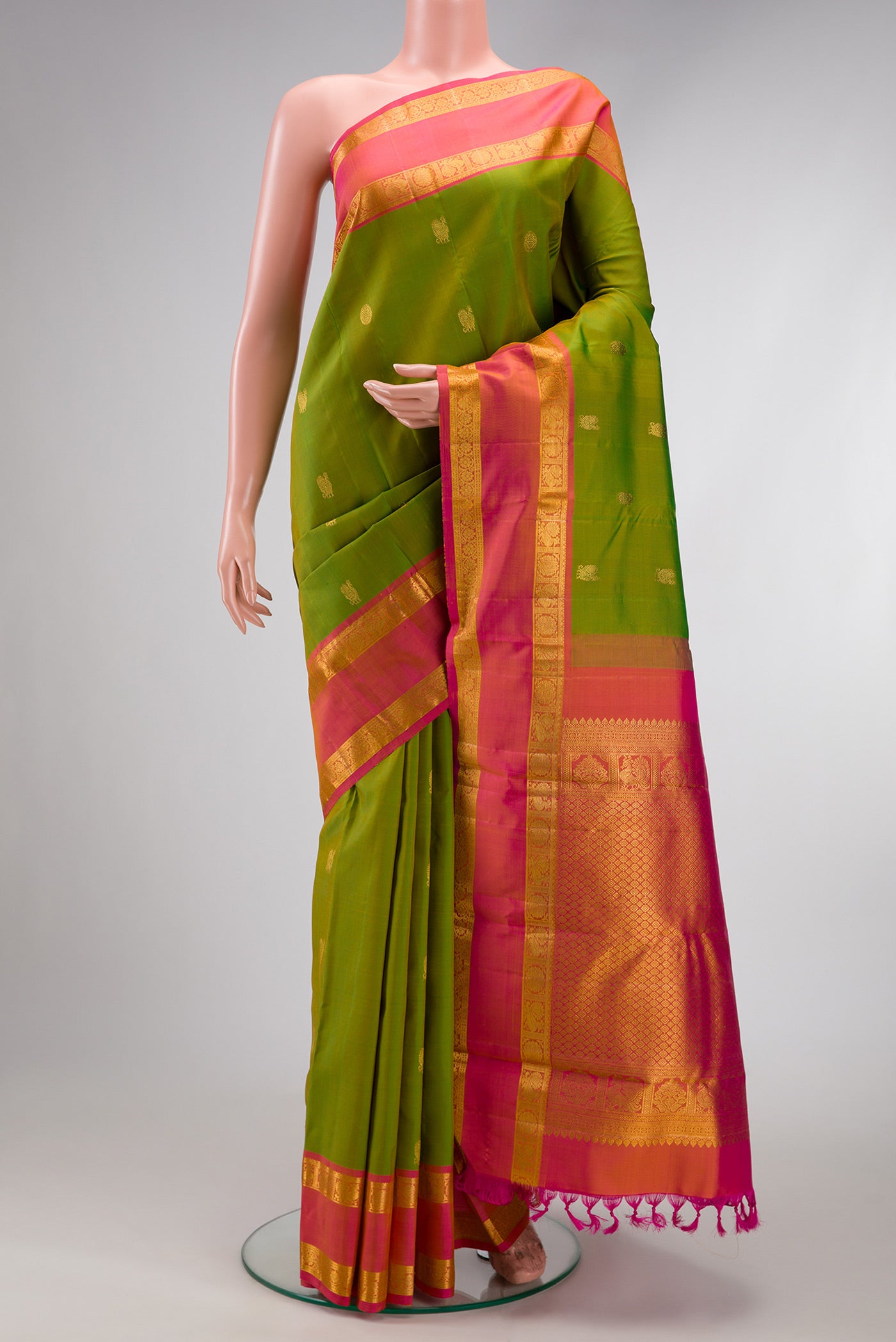 Green Dual Tone Kanjivaram Silk Saree with Zari Butta on the body and Zari Border.  displayed on a mannequin