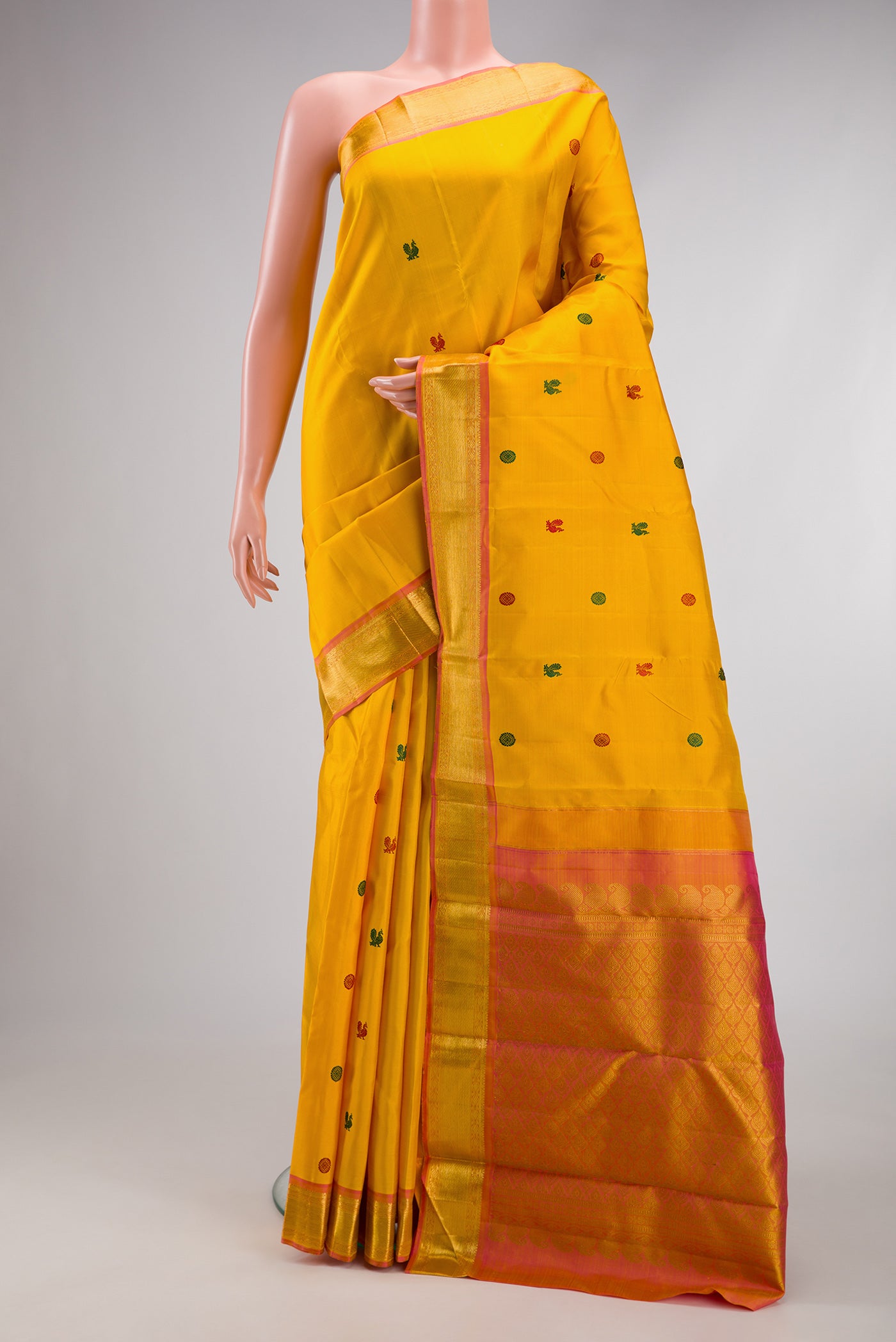Yellow Kanjivaram Silk Saree with Thread Butta on the body and Zari Border.  displayed on a mannequin