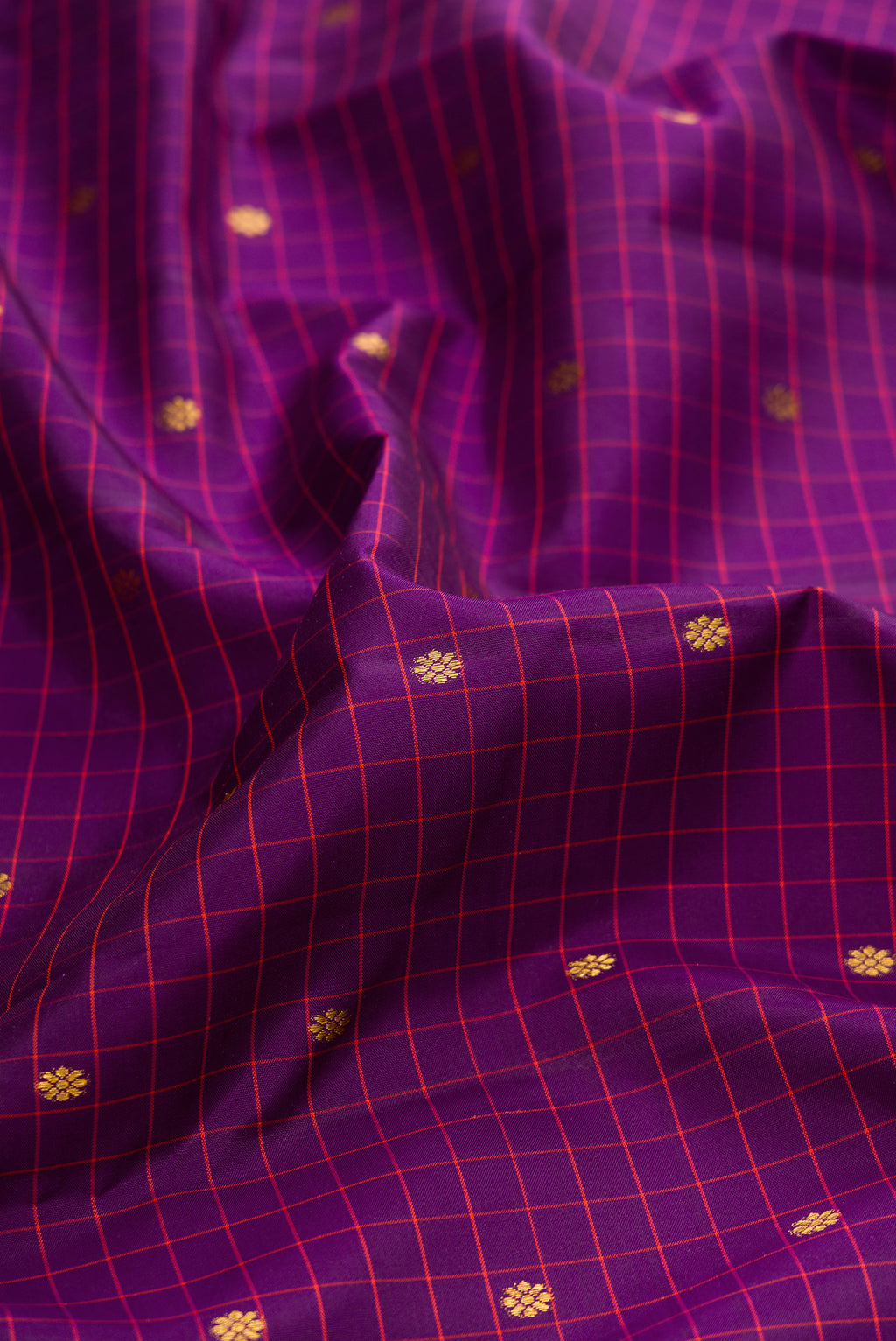 Close up of Purple Dual Tone Kanjivaram Silk Saree with Checked design on the body and Zari Border.  displaying folds