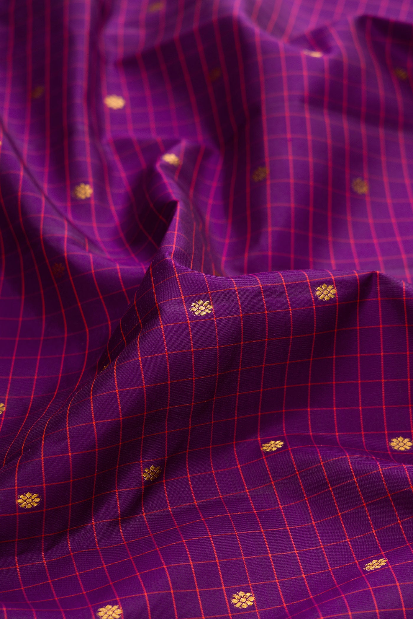 Close up of Purple Dual Tone Kanjivaram Silk Saree with Checked design on the body and Zari Border.  displaying folds