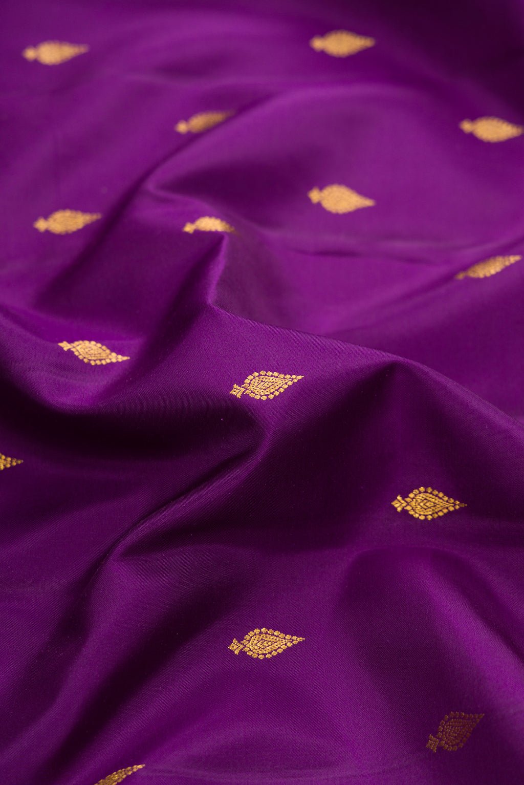 Close up of Purple Dual Tone Kanjivaram Silk Saree with Zari Butta on the body and Zari Border.  displaying folds