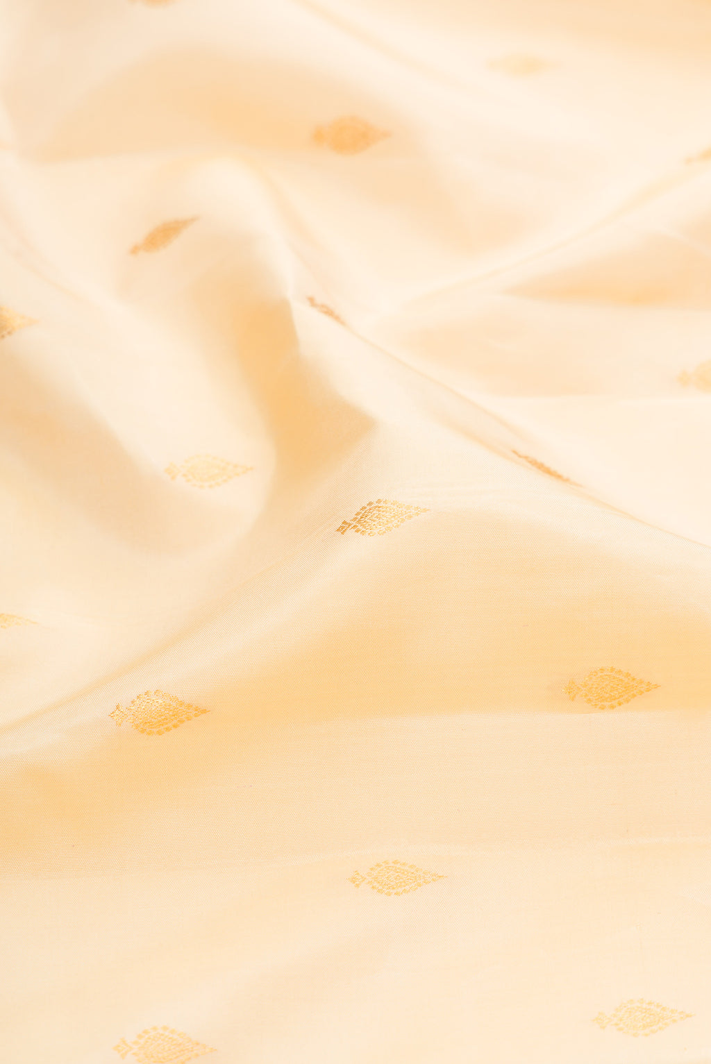 Close up of Sandal Kanjivaram Silk Saree with Zari Butta on the body and Zari Border.  displaying folds