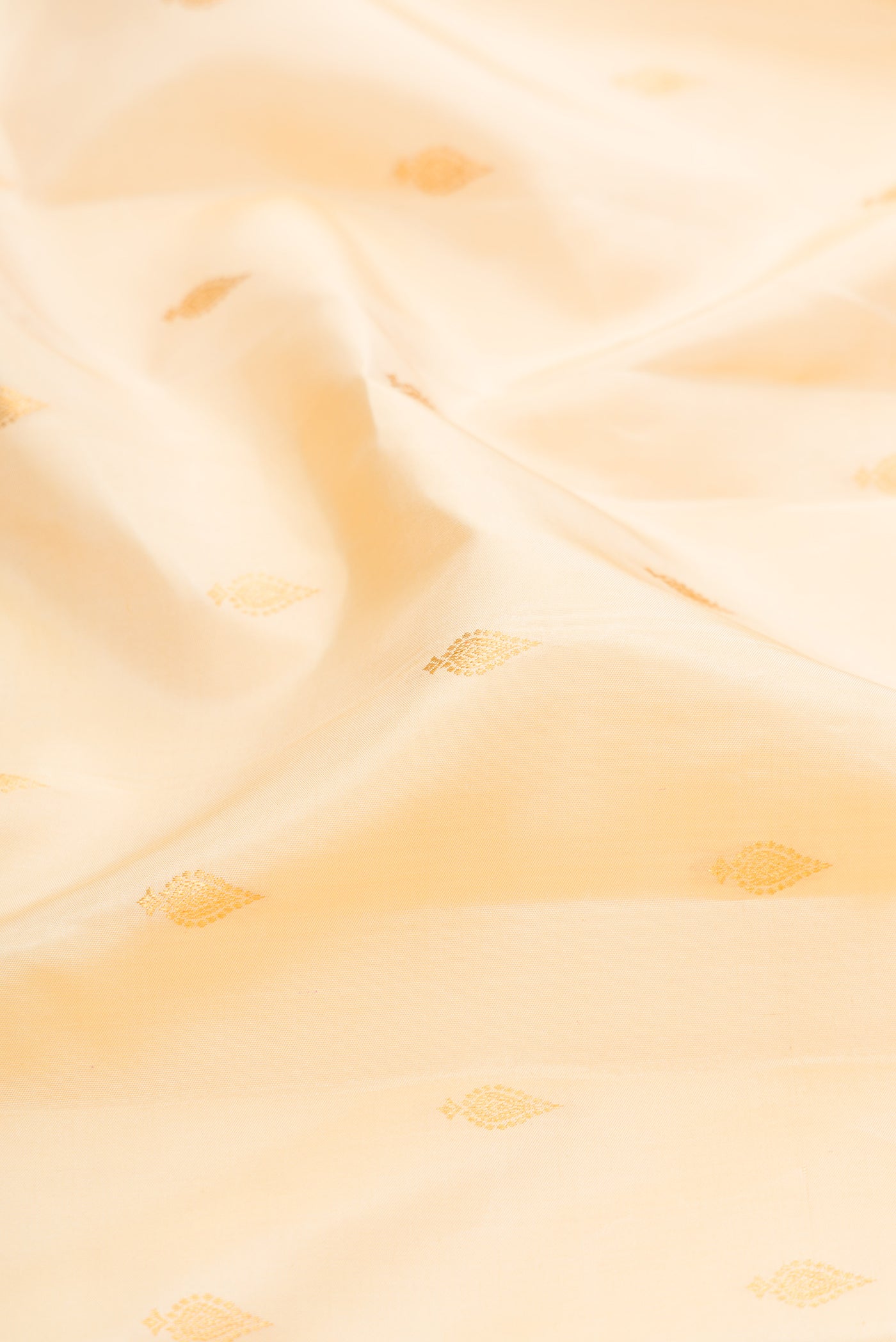 Close up of Sandal Kanjivaram Silk Saree with Zari Butta on the body and Zari Border.  displaying folds