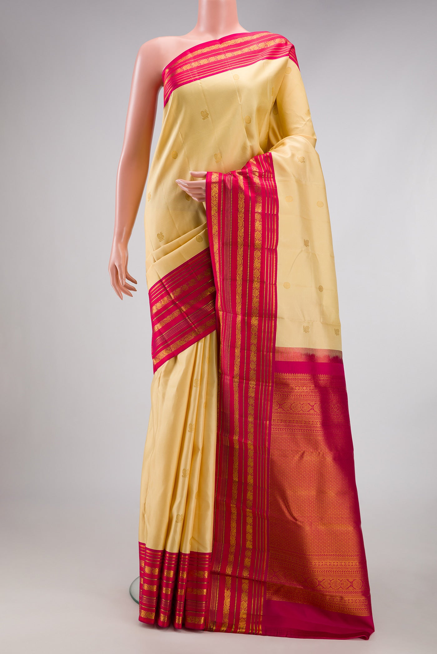 Sandal Kanjivaram Silk Saree with Zari Butta on the body and Zari Border.  displayed on a mannequin