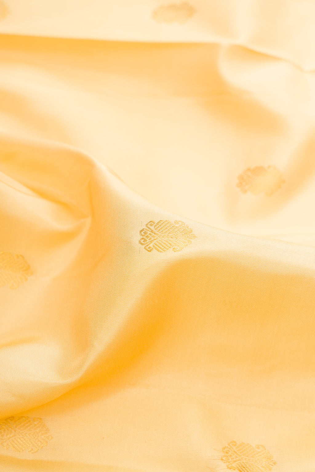 Close up of Pure Silk Sandal Kanjivaram Saree with Zari Butta on the body and Zari Border.  displaying folds