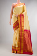 Pure Silk Sandal Kanjivaram Saree with Zari Butta on the body and Zari Border.  displayed on a mannequin
