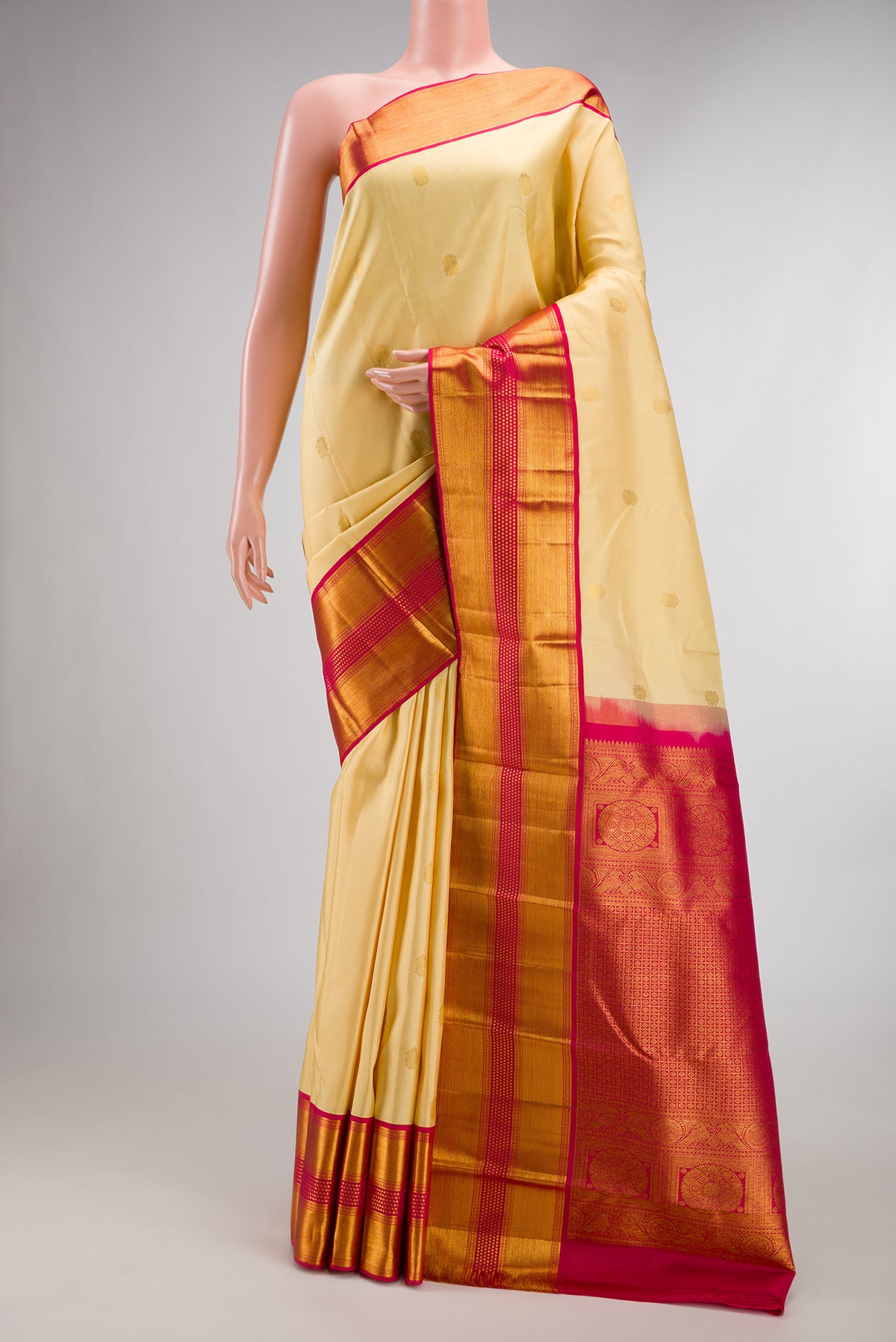Pure Silk Sandal Kanjivaram Saree with Zari Butta on the body and Zari Border.  displayed on a mannequin